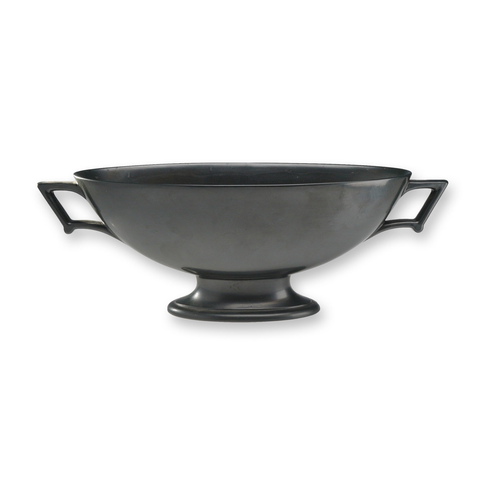 Wedgwood Bateau Bowl with Handles, Ravenstone Matte Black: A Wedgwood earthenware centerpiece bowl in the Bateau form, finished in a Ravenstone matte black glaze. The vessel features an elongated oval body with a deep well, supported by a circular pedestal fo