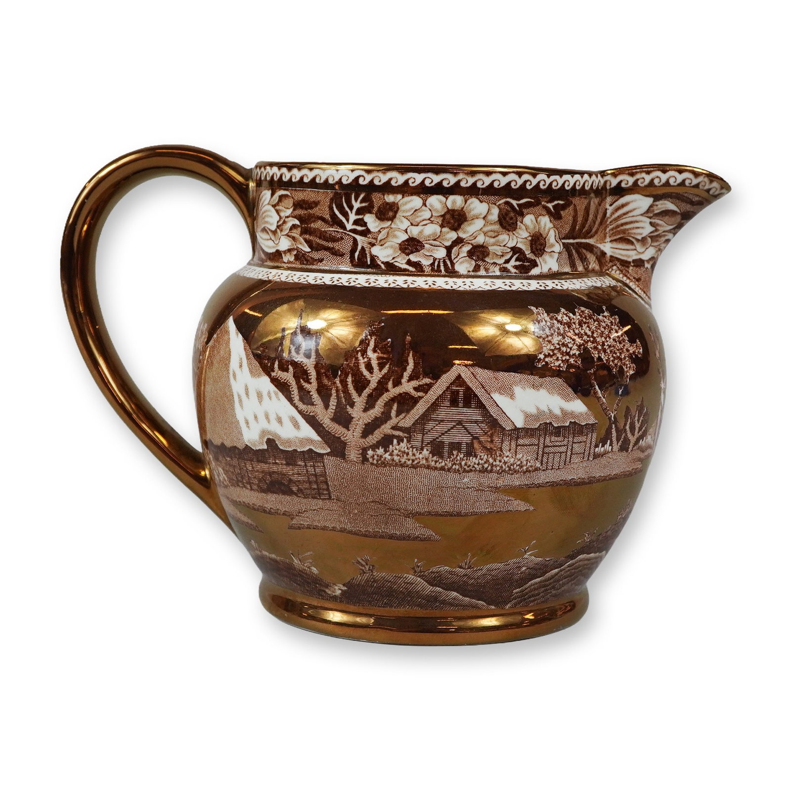 Wedgwood Fallow Deer Pattern Copper Lustre Creamer: This small earthenware creamer was manufactured by Wedgwood and features the Fallow Deer pattern. The vessel is designed with a globular body, a flared rim, a small pouring spout, and a single loop ha