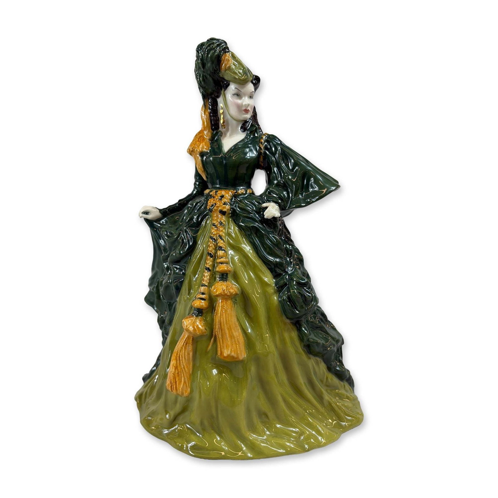 Royal Doulton Gone With The Wind Bone China Figurine, Scarlett O'Hara HN4200: The figure is modeled wearing the green curtain dress with heavy gold-color corded tassels at the waist and a matching hat with feather detail. The underside features the printed Royal Doulton backsta