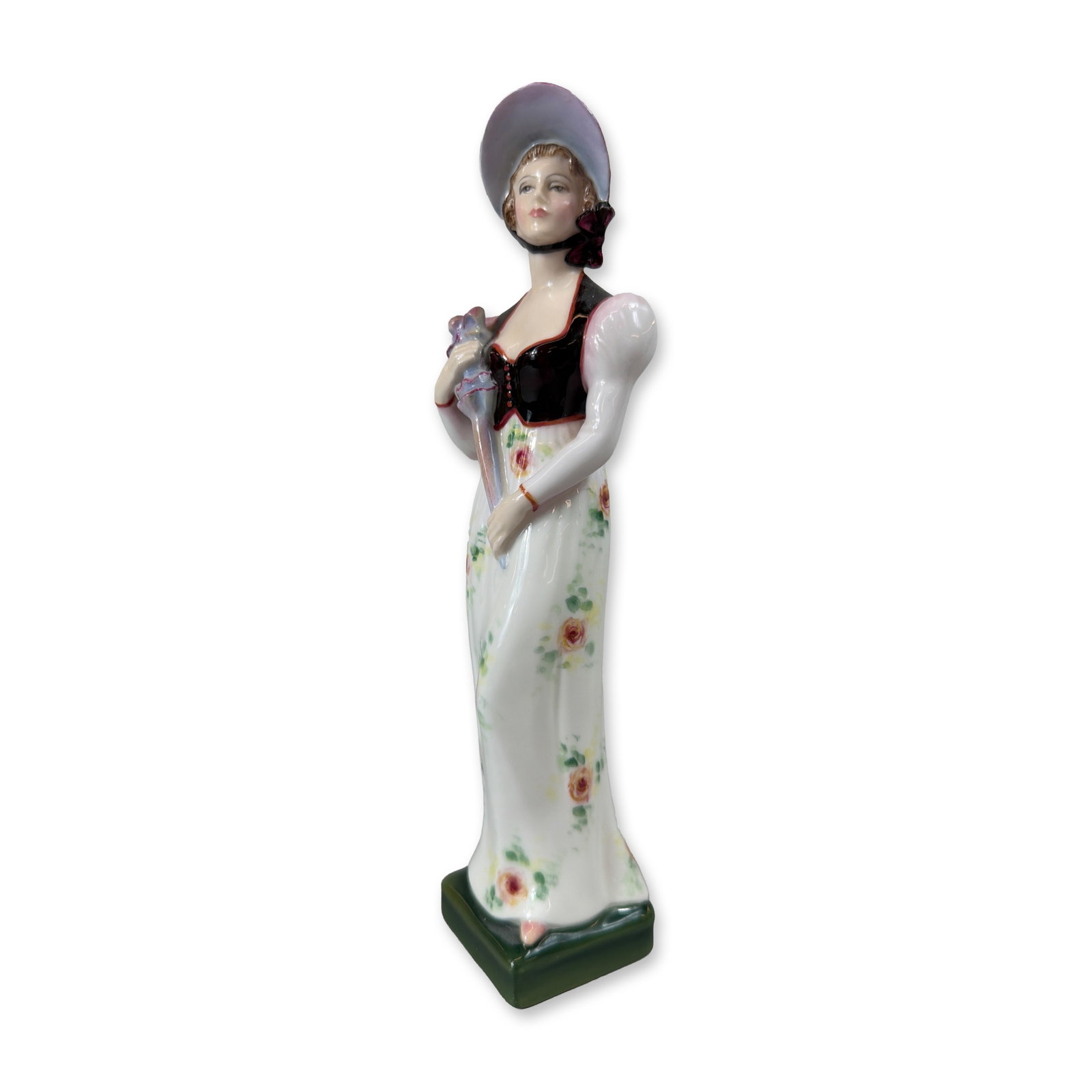 Royal Doulton Prototype Lady Figurine: This Royal Doulton bone china figurine depicts a standing woman in early 20th-century style attire, wearing a wide-brimmed lavender and pink bonnet with a dark plum ribbon, a black waistcoat bodice ov