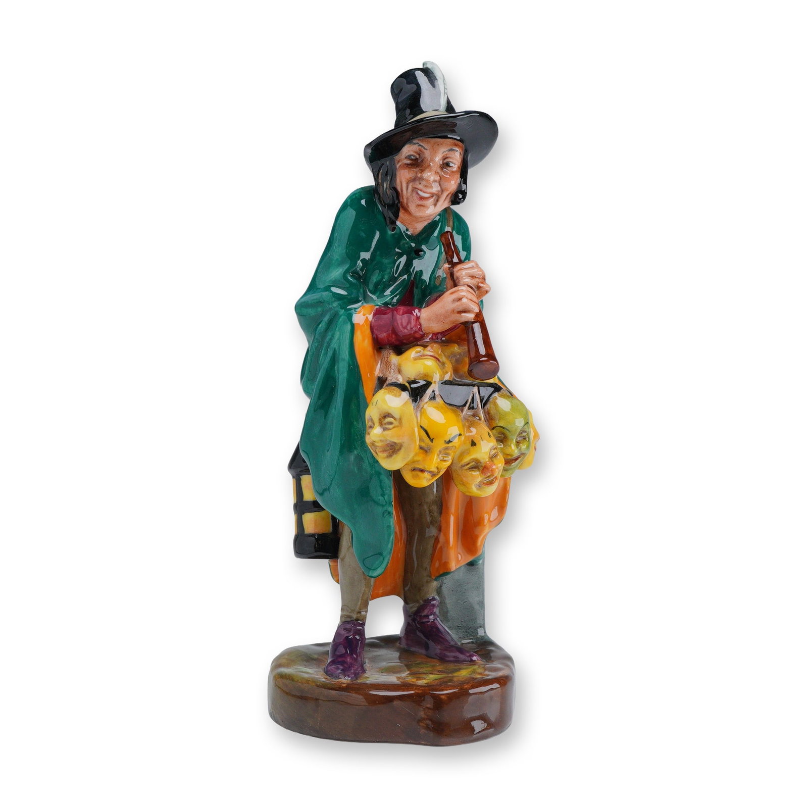 Royal Doulton Porcelain Figurine, Mask Seller HN2103: A vintage Royal Doulton glazed polychrome porcelain figurine titled "The Mask Seller," model number HN 2103. This piece depicts a characterful itinerant vendor wearing a deep green cloak, red tunic, a