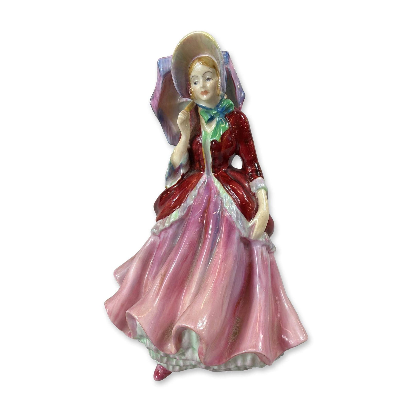 Paragon Lady Patricia Bone China Figurine: Paragon Fine Bone China figurine titled Lady Patricia, depicting a standing female figure in historical attire. The figure is modeled wearing a wide-brimmed bonnet with a blue and green bow, holding a