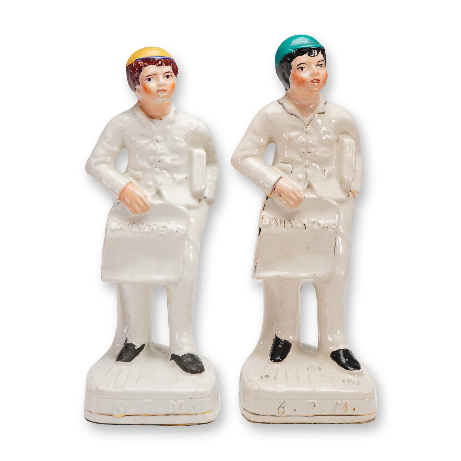 2pc Antique Staffordshire Sculptures , Daily News 6PM: Victorian-era Staffordshire porcelain figurines depicting young newspaper delivery boys, each holding a "Daily News" bag marked 6 P.M. at the base. These figures, commonly attributed to Staffordshire 