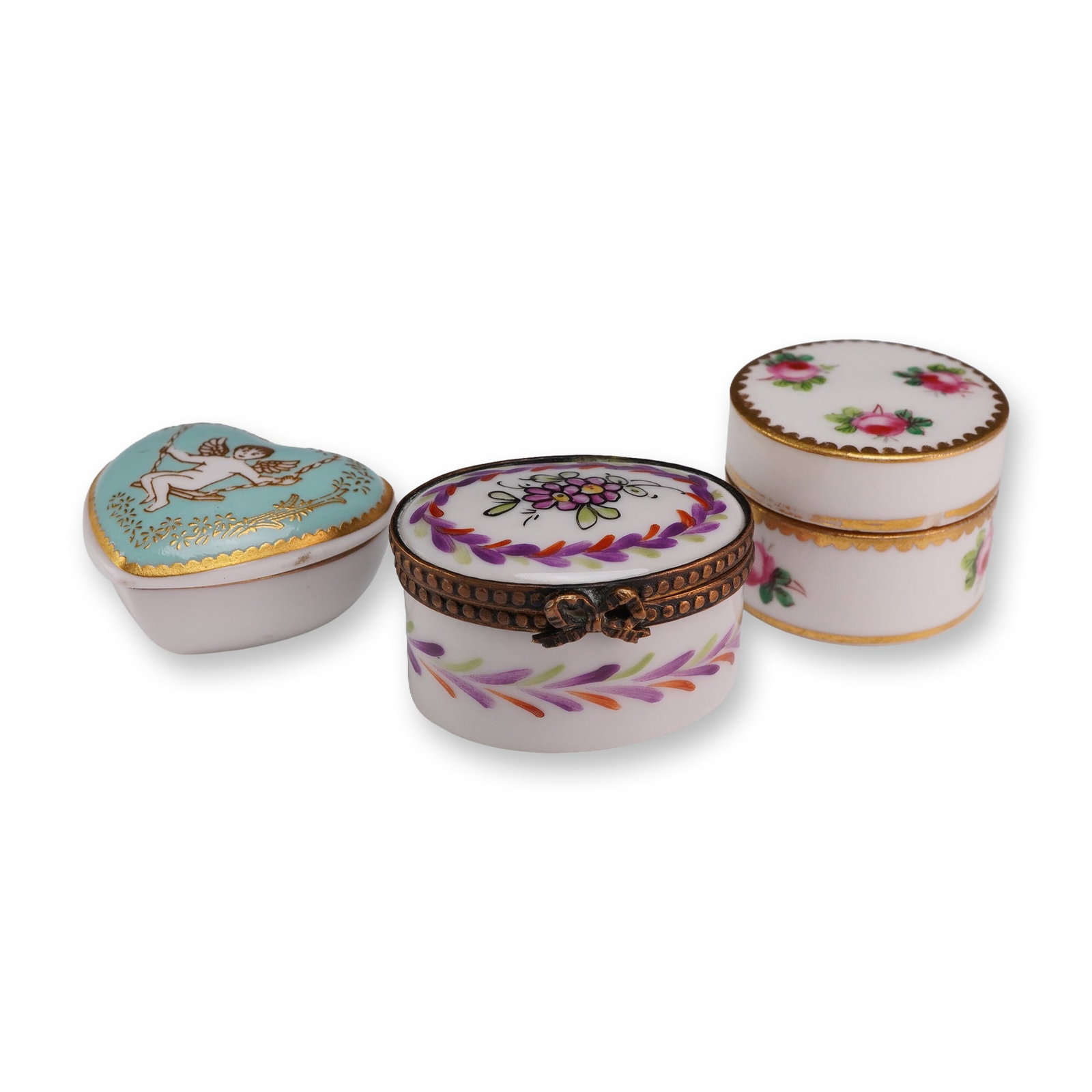 3pc Spode, Mintons, and Continental Miniature Porcelain Trinket Boxes: Collection of three English and Continental ceramic trinket boxes. Includes one Spode bone china heart-shaped box featuring a turquoise lid with a transfer-printed cupid on a swing and gilded scroll b