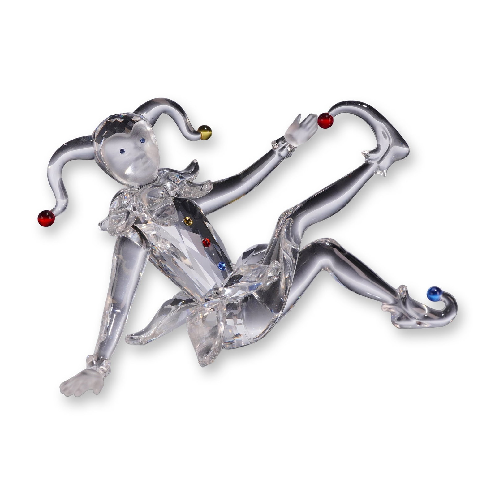 Swarovski Crystal Jester Figurine with Box: Swarovski crystal figurine, Jester, model number 275555. Faceted clear lead crystal figure in a reclining pose with frosted crystal accents on the face and hands. Features colored crystal spheres in r