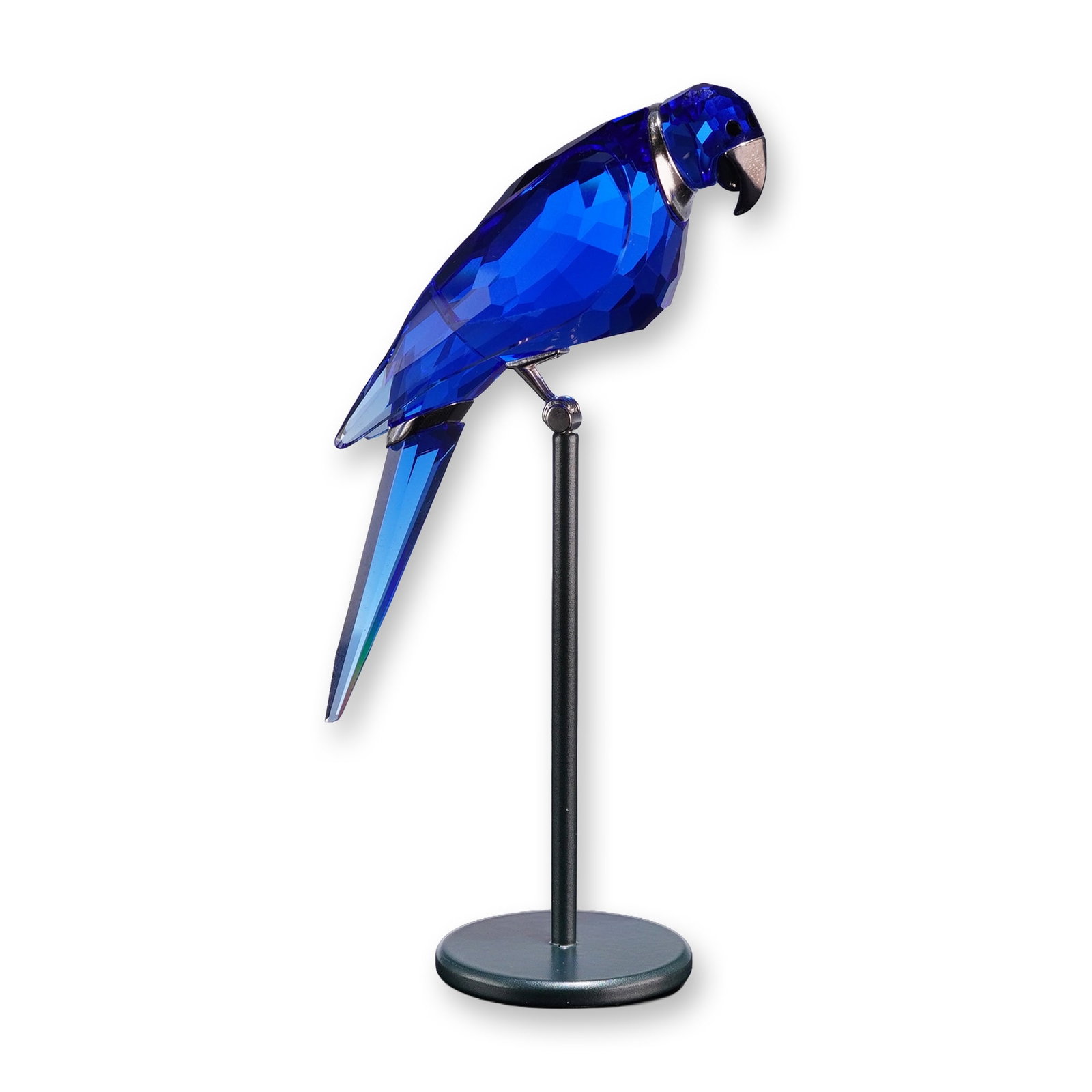 Swarovski Paradise Birds Crystal Figurine, Balabac Sapphire: Swarovski. Paradise bird figurine, model Balabac, crafted in faceted sapphire blue crystal with a lighter blue tail. The figurine features a silver-tone metal beak, collar, and perch attachment, and s