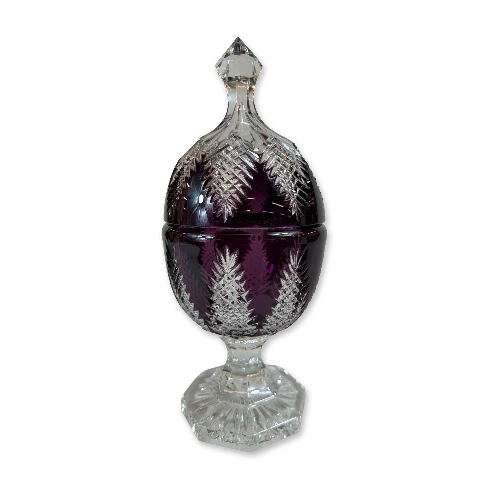 Bohemian Style Amethyst Cut to Clear Crystal Covered Urn: Bohemian style amethyst cut-to-clear crystal covered urn. The egg-shaped body and matching lid feature deeply cut mitered panels depicting stylized pinecones or leaves, filled with fine strawberry dia