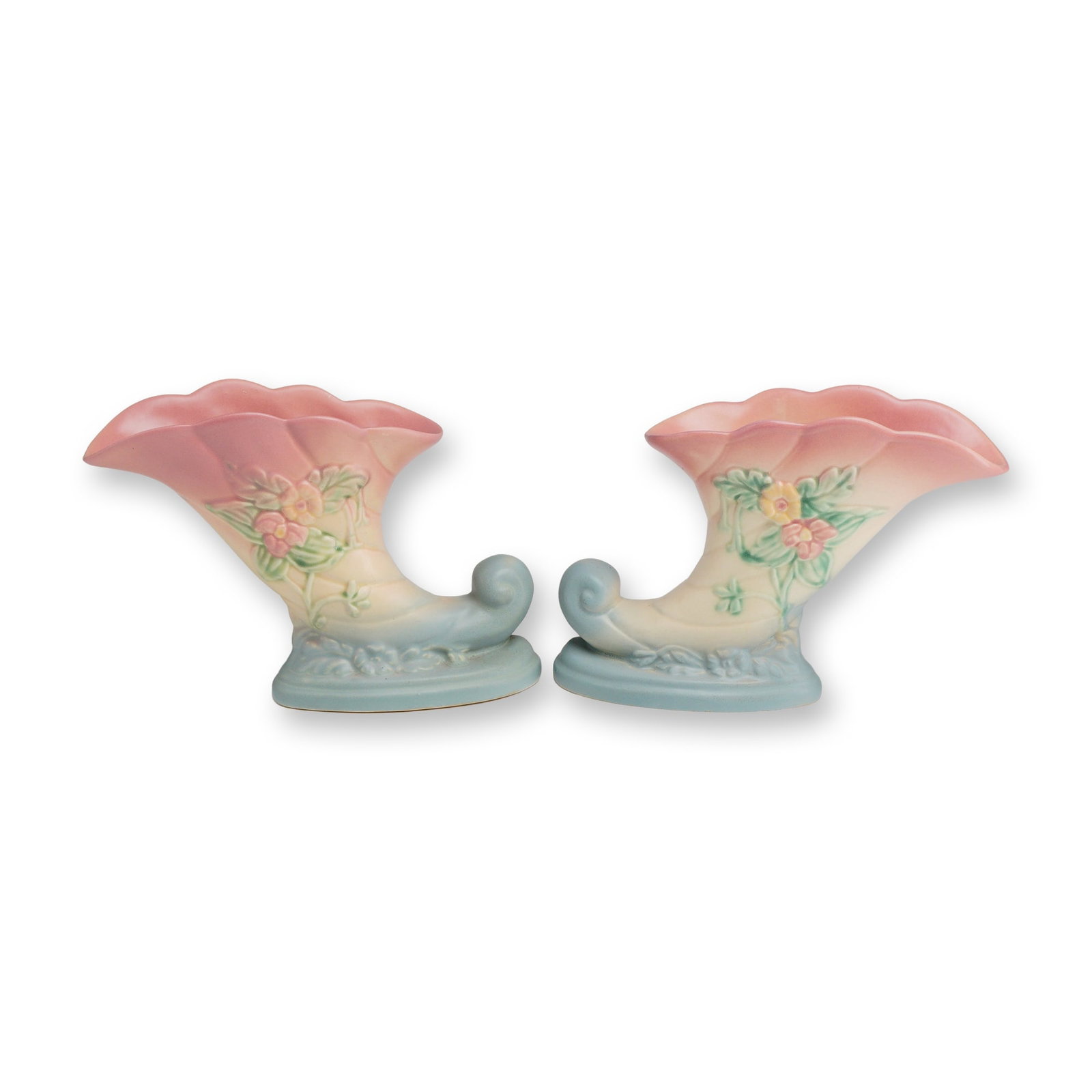 Pair of Hull Wildflower Cornucopia Vases: This pair of mid-20th century ceramic cornucopia vases is a quintessential example of American matte-glaze art pottery, produced by Hull Art Pottery in the beloved Wildflower pattern. Introduced in th