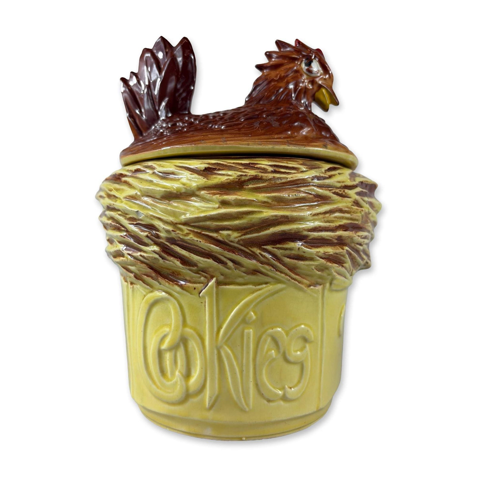 McCoy Ceramic Hen on Nest Cookie Jar: American earthenware cookie jar by McCoy Pottery, mid-20th century. The piece is modeled as a hen on a nest, featuring a brown-glazed lid shaped as a hen with red and yellow accents. The pale yellow b