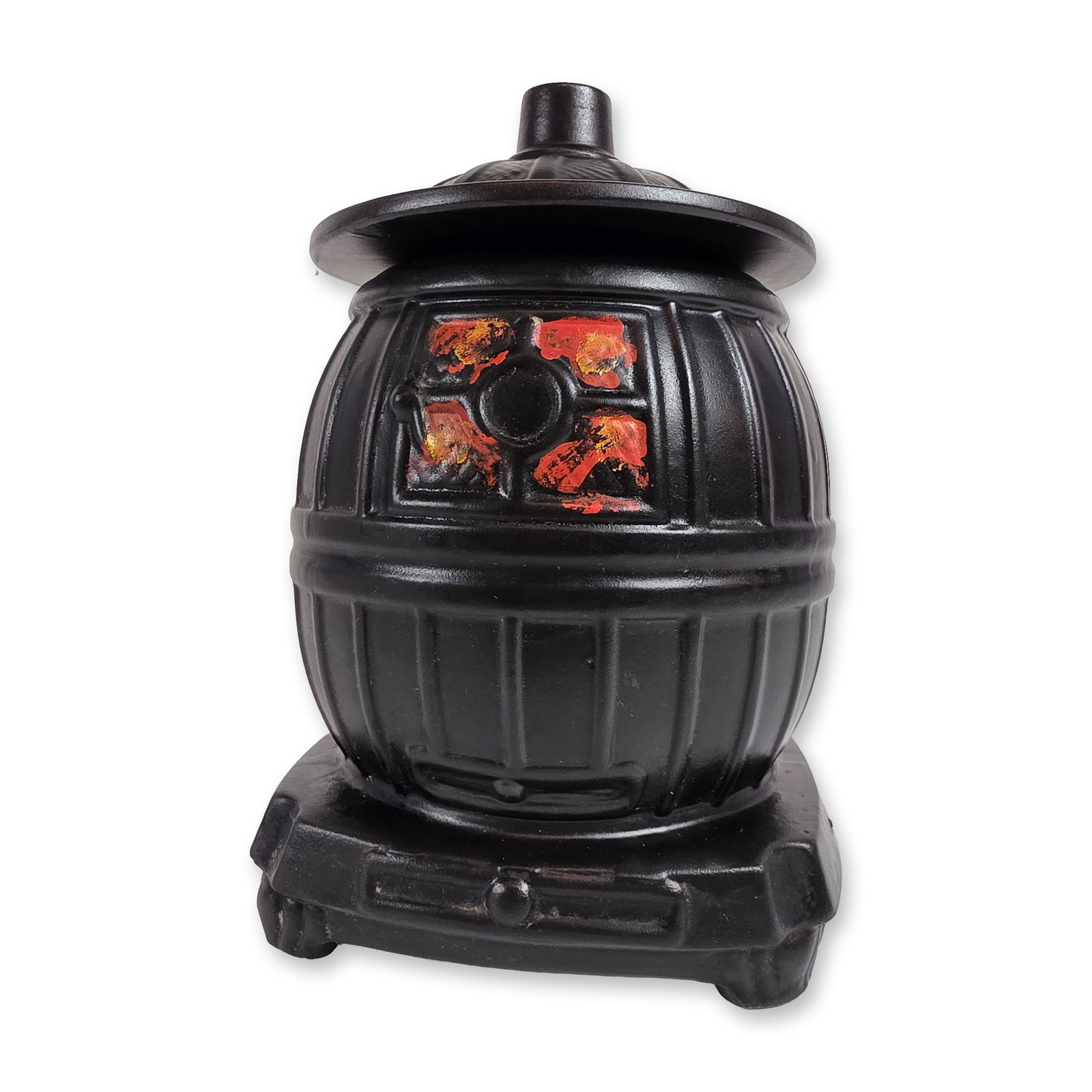 McCoy Ceramic Potbelly Stove Cookie Jar: McCoy Pottery vintage cookie jar designed in the form of a traditional potbelly stove. The piece is constructed from molded ceramic finished in a matte black glaze to simulate cast iron. The design fe