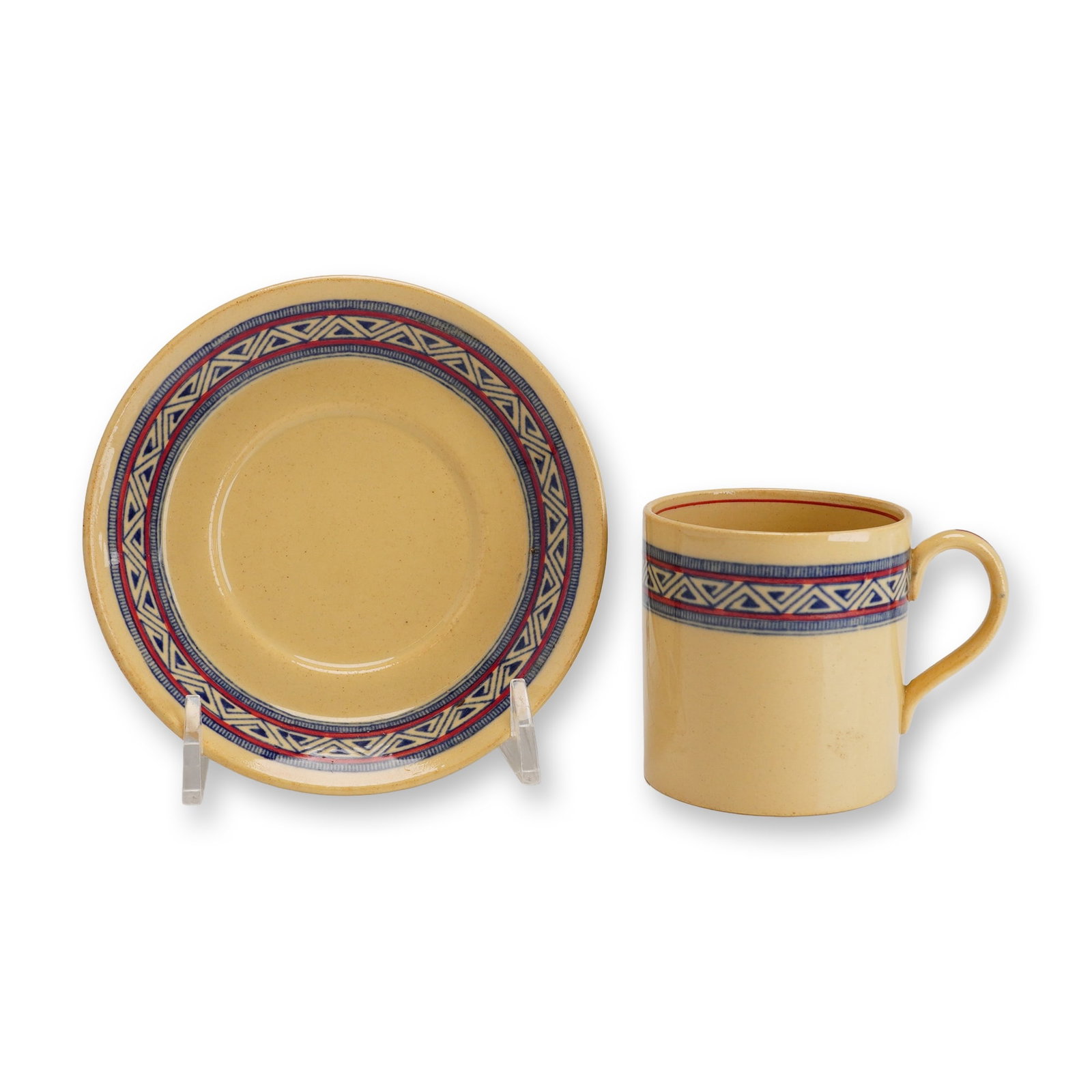 2pc Wedgwood Earthenware Cup and Saucer Set Pieces, Pattern A 7615: This Wedgwood earthenware cup and saucer set features a tan body decorated with a continuous geometric design. Produced at the Etruria factory in England, both pieces are finished with a border band i