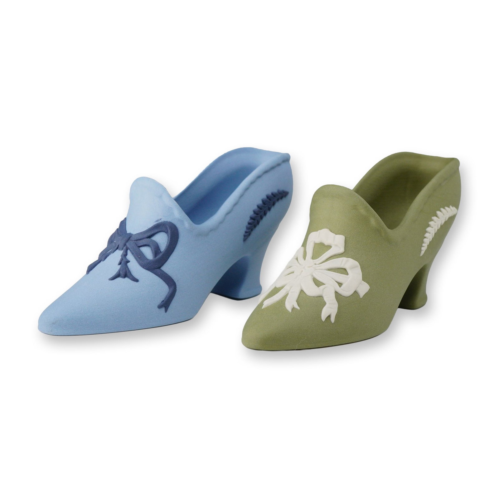 2pc Wedgwood Jasperware Miniature Shoe Figurines: Two Wedgwood jasperware miniature shoe figurines produced in England. This lot includes one shoe in a light blue color with dark blue applied relief sprigging and a second shoe in a sage green color w