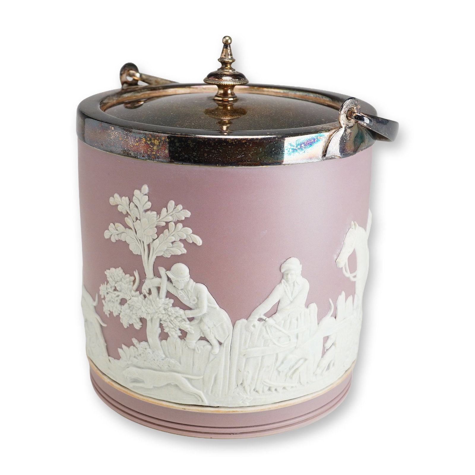 Wedgwood Lilac Jasperware Biscuit Barrel: A cylindrical lilac jasperware biscuit barrel featuring applied white bas-relief sprigged decoration depicting a traditional fox hunting scene. The relief motifs include hunters, hounds, a horse, and 