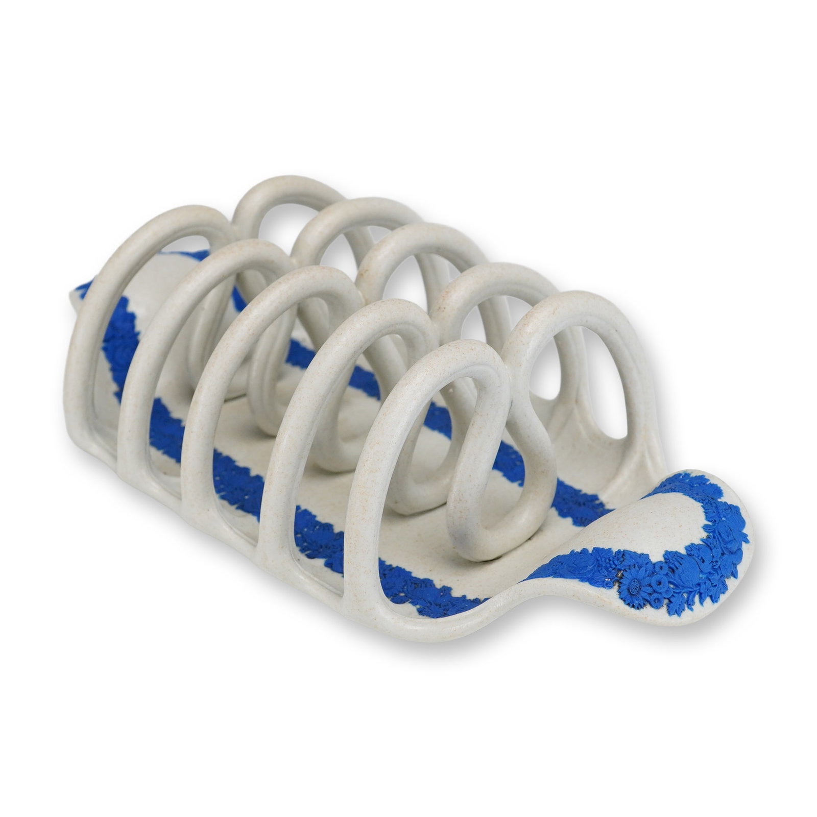 Wedgwood White and Blue Sprigged Jasperware Toast Rack: A Wedgwood white jasperware toast rack featuring six slots formed by five loops set upon an integral rectangular base. The refined white stoneware body is decorated with applied blue sprigged reliefs 