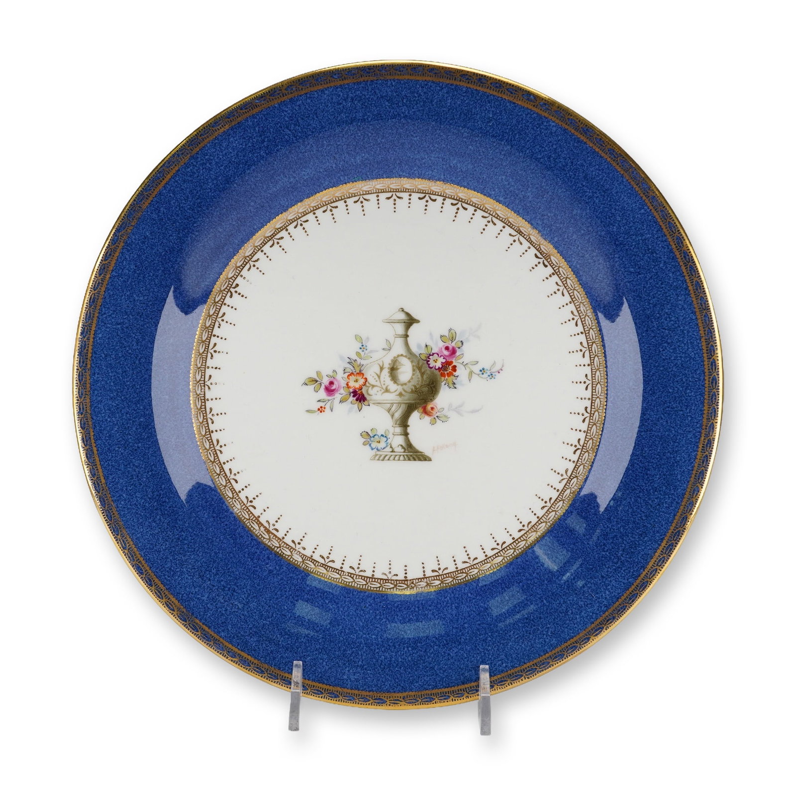 A Wedgwood Hand-Painted Neoclassical Porcelain Plate Signed A. Holland: A Wedgwood Neoclassical decorative plate featuring a deep cobalt blue textured border adorned with multiple intricate gilt bands. The central white ground displays a sepia-toned classical urn motif, e