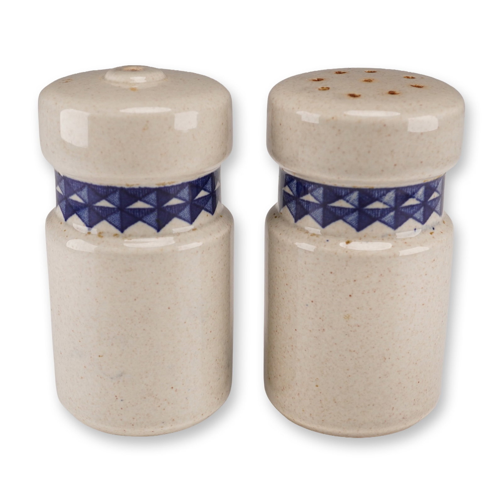 A Pair of Wedgwood 'Mexico' Ceramic Salt and Pepper Shakers: A pair of Wedgwood 'Mexico' ceramic salt and pepper shakers, circa 1970s. Each shaker features a cylindrical form with a speckled off-white/beige glazed body. A distinctive band of dark blue geometric