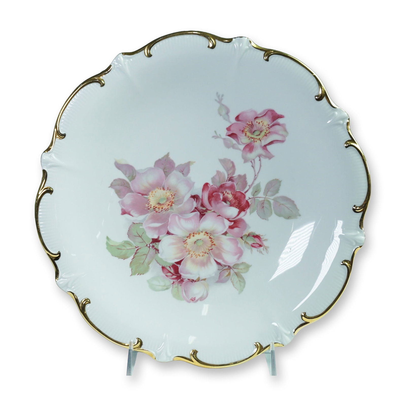 Schumann Arzberg Bavaria Wild Rose Charger for Golden Crown E&R: Decorative porcelain charger plate featuring the Wild Rose pattern, produced by Schumann Arzberg Bavaria and distributed by Golden Crown E&R. The plate showcases a bouquet of hand-painted-style pink