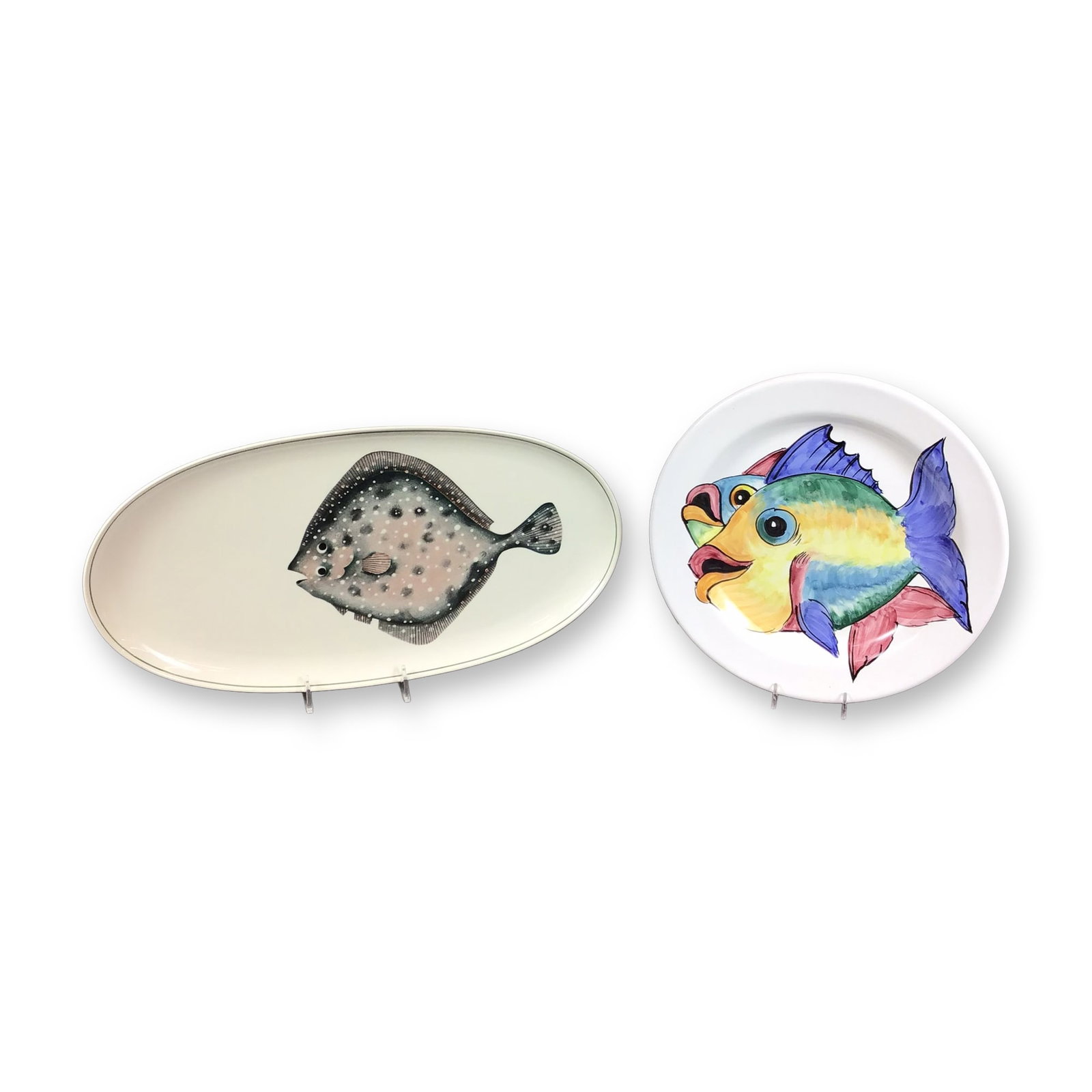 2pc Villeroy and Boch and Michelangelo Raffaello Ceramic Fish Platters: This lot features two ceramic serving pieces with fish motifs. The first is a large oval serving platter manufactured by Villeroy and Boch in the Atlantic pattern. Crafted from vitra-porcelain, the pi