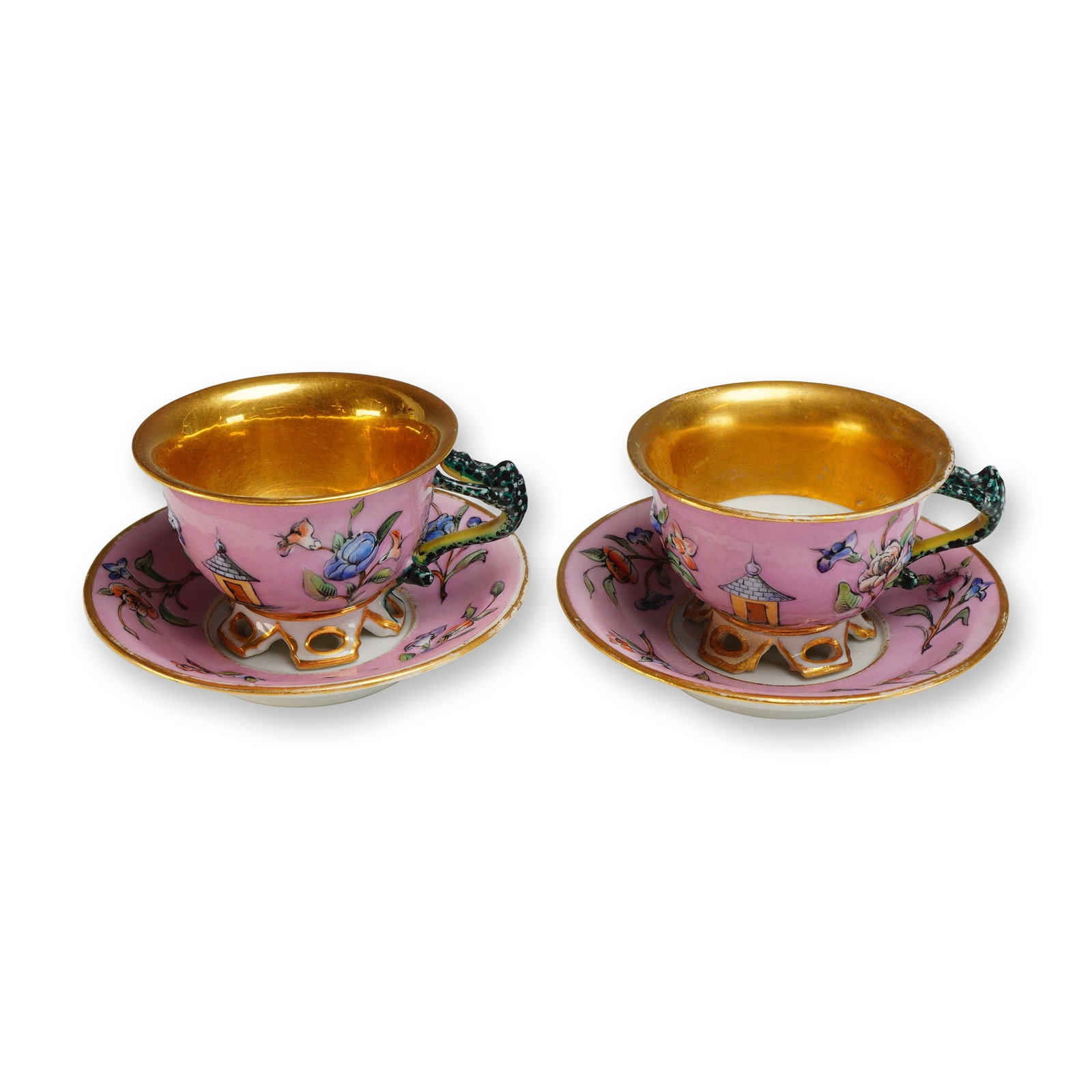 4pc Hand Painted and Gilded Ornate Porcelain Teacups and Saucers: This lot consists of two sets of vintage porcelain teacups and saucers, totaling four pieces. Each cup and saucer features a pink ground decorated with hand-painted Chinoiserie motifs, including