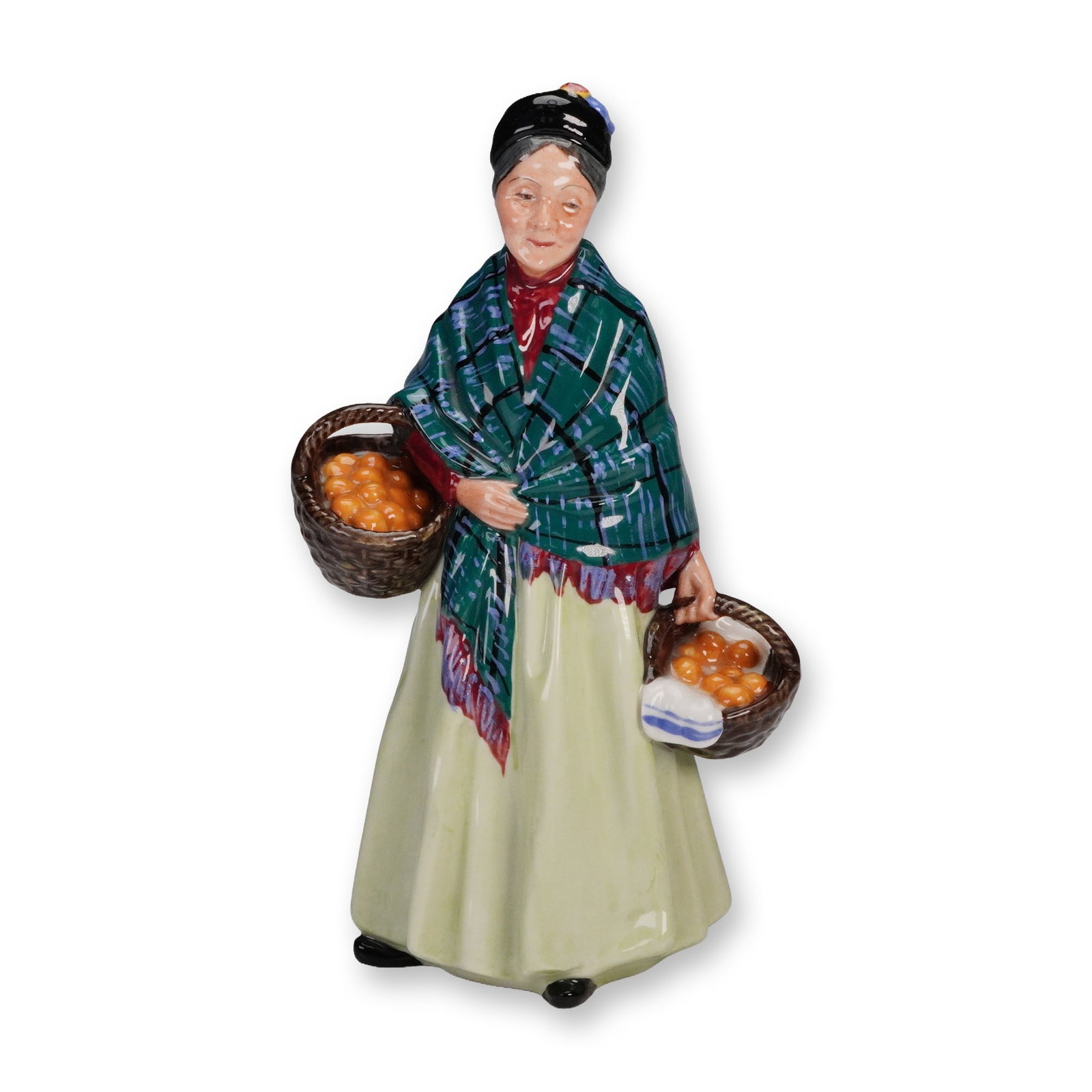 Royal Doulton Figurine, Orange Lady HN1953: A Royal Doulton figurine titled Orange Lady HN1953, depicting an elderly woman carrying baskets of oranges, dressed in a patterned green shawl, red blouse, and pale skirt. The figurine is finely detai