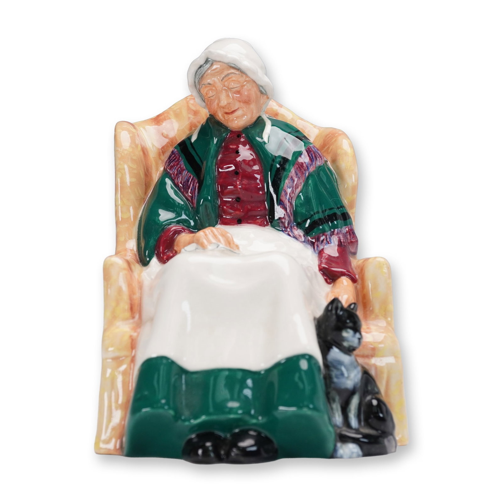 Royal Doulton Porcelain Figurine, Forty Winks HN1974: Made in England by Royal Doulton, this charming hand-painted porcelain figurine titled Forty Winks (HN1974) captures a serene domestic moment of an elderly woman dozing in an upholstered armchair, her