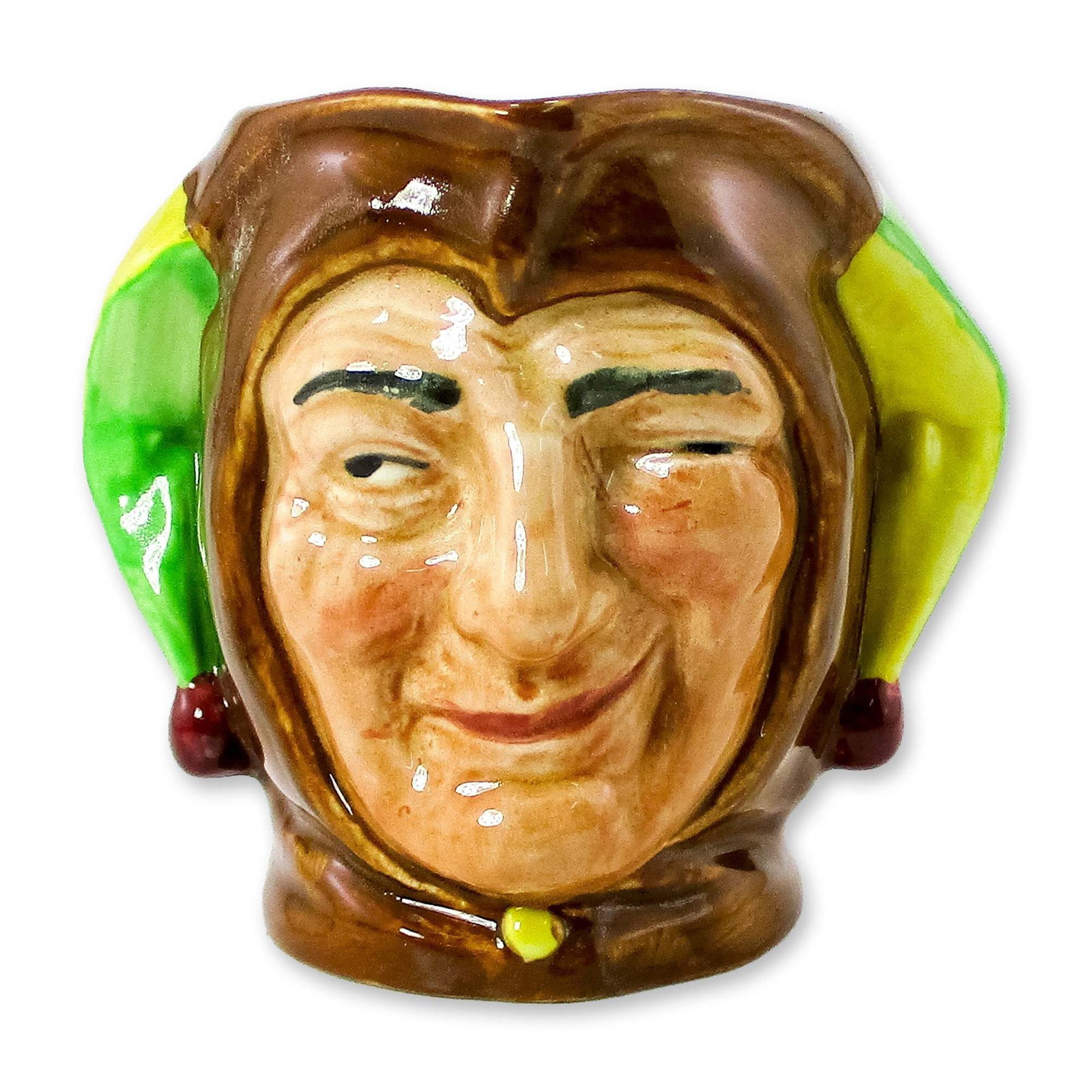 Jester D5556 - Small - Royal Doulton Character Jug: Brown, green and yellow coloration. The green and yellow coloring on either side of the hat may be reversed as a preference of the painter. Artist: Charles Noke Dimensions: 3.25"H Date or Era: 1936 - 