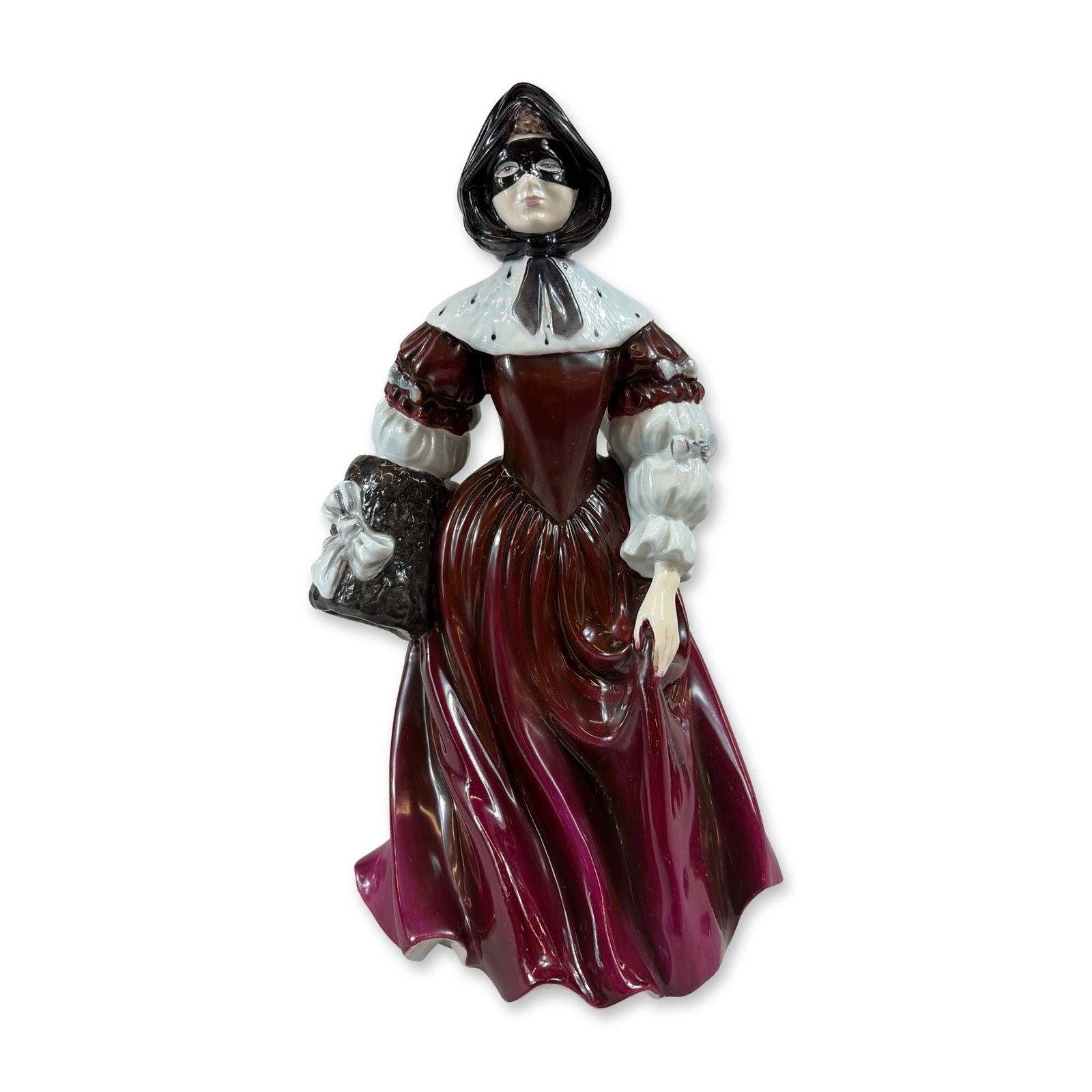 Coalport Bone China Figurine, Restoration Stuart: Representing the period 1660 to 1689 and modeled by John Bromley. The figure is depicted in historical masquerade attire, wearing a black mask and hood, a spotted white collar with a black bow, a choc