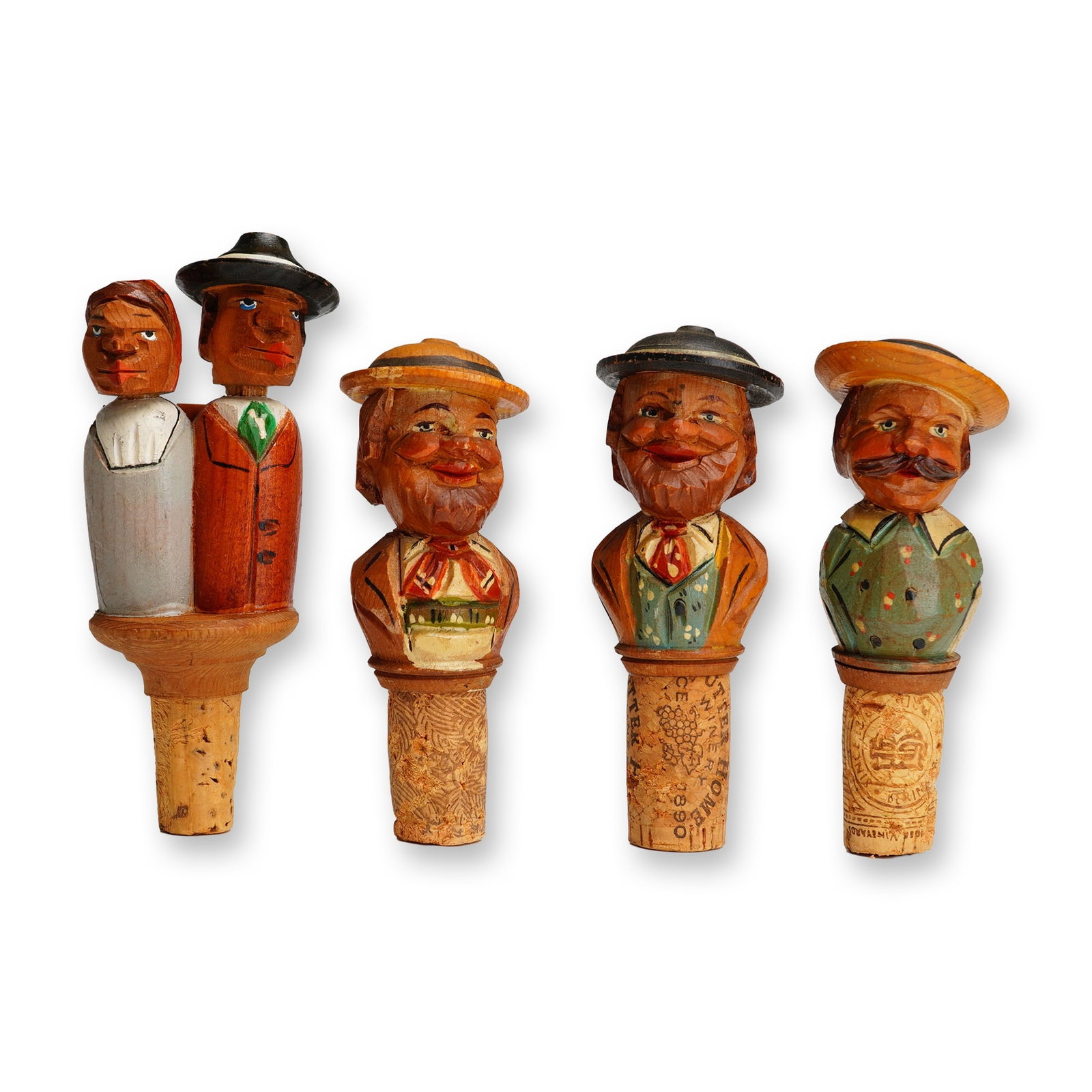 Alpine Folk Figures, Hand-Carved Wooden Bottle Stoppers: This lot consists of four vintage hand-carved and polychrome painted wooden bottle stoppers, likely produced in the South Tyrol region of Italy in the style of the Anri workshop. The set features thre