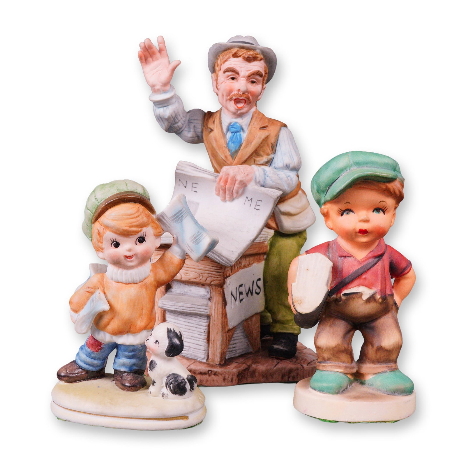 Three Mid-to-Late 20th Century Painted Ceramic News Vendor and Newsboy: A group of three painted ceramic figurines depicting a street scene centered around a newsstand. The central figure portrays an adult news vendor in a hat and vest, gesturing, standing behind a newsst