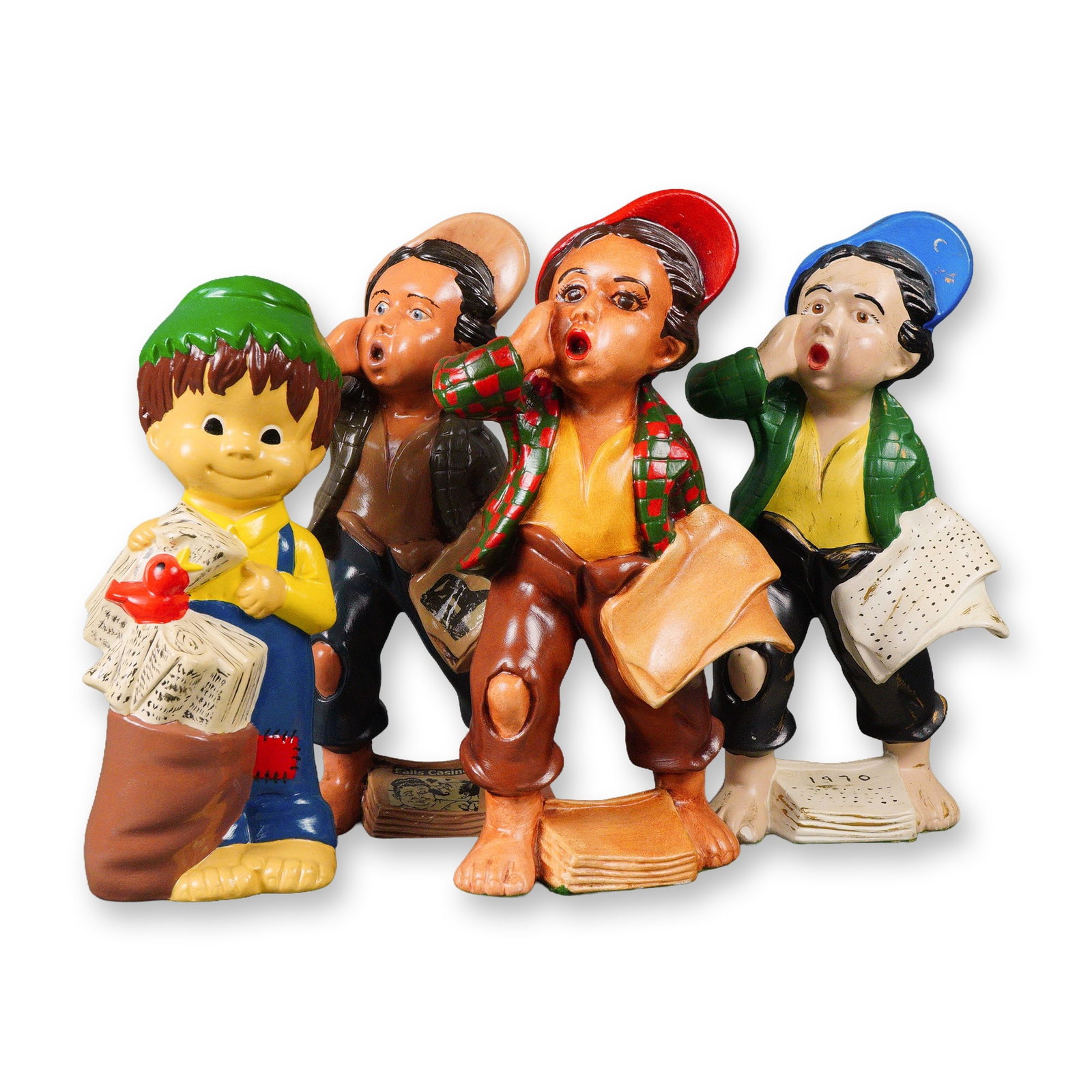 A Group of Four Ceramic Newspaper Boy Figurines, N. Cox, Dated 1970: Three figures depict expressive young newsboys with bare feet, tattered clothing, and colorful caps, caught in dynamic poses as if shouting and holding newspapers. The fourth figure is a more stylized