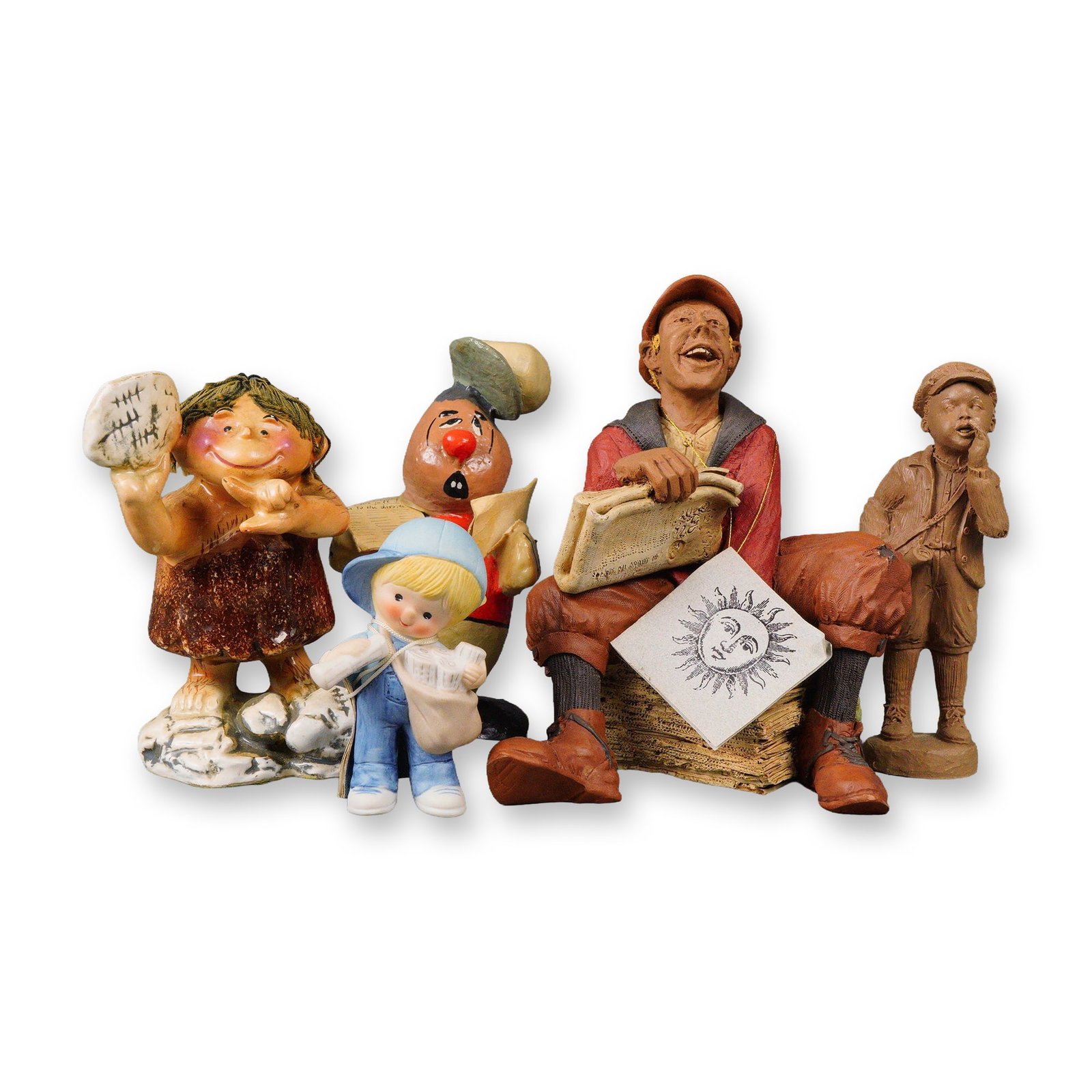 A Group of Five Newspaper Figurines: A group of five late 20th-century figurines, primarily crafted from painted resin or ceramic, displaying a whimsical, cartoonish, and expressive style. The group features a laughing news vendor seated