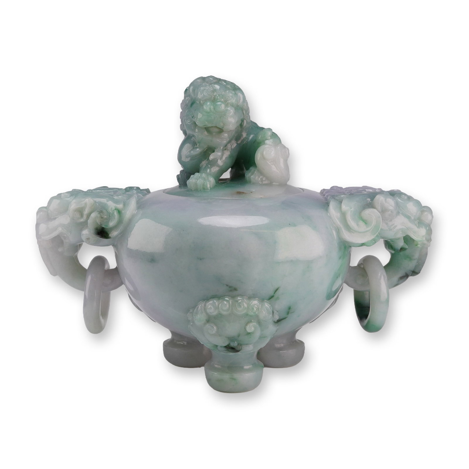 Jadeite Tripod Censer, Buddhist Lion Finial and Handles: This tripod jadeite censer with a lid features hues ranging from bluish-white to green. It has a lion finial on the lid and lion head handles with rings hanging from them. Dimensions: 6"L x 3.5"W x 4.