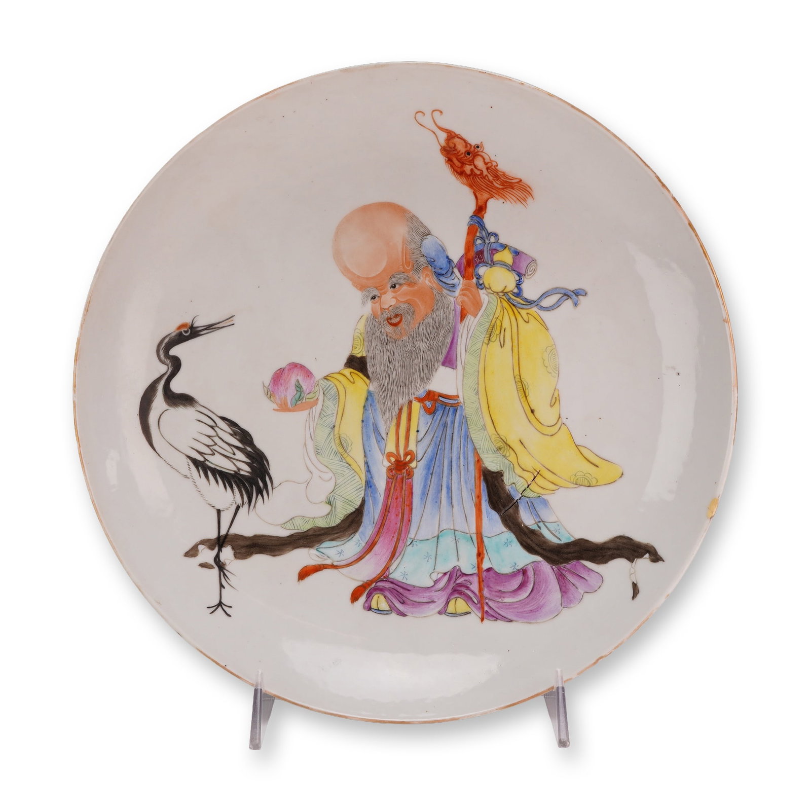 Famille Rose Porcelain Dish, Shou Lao and Crane, Ex-Regal Collection: A round white famille rose porcelain dish hand-decorated with an illustration of Shou Lao offering a fruit to a crane. The underside bears a blue seal mark. Dimensions: 2"H x 10.5" dia. Weight: 2.11