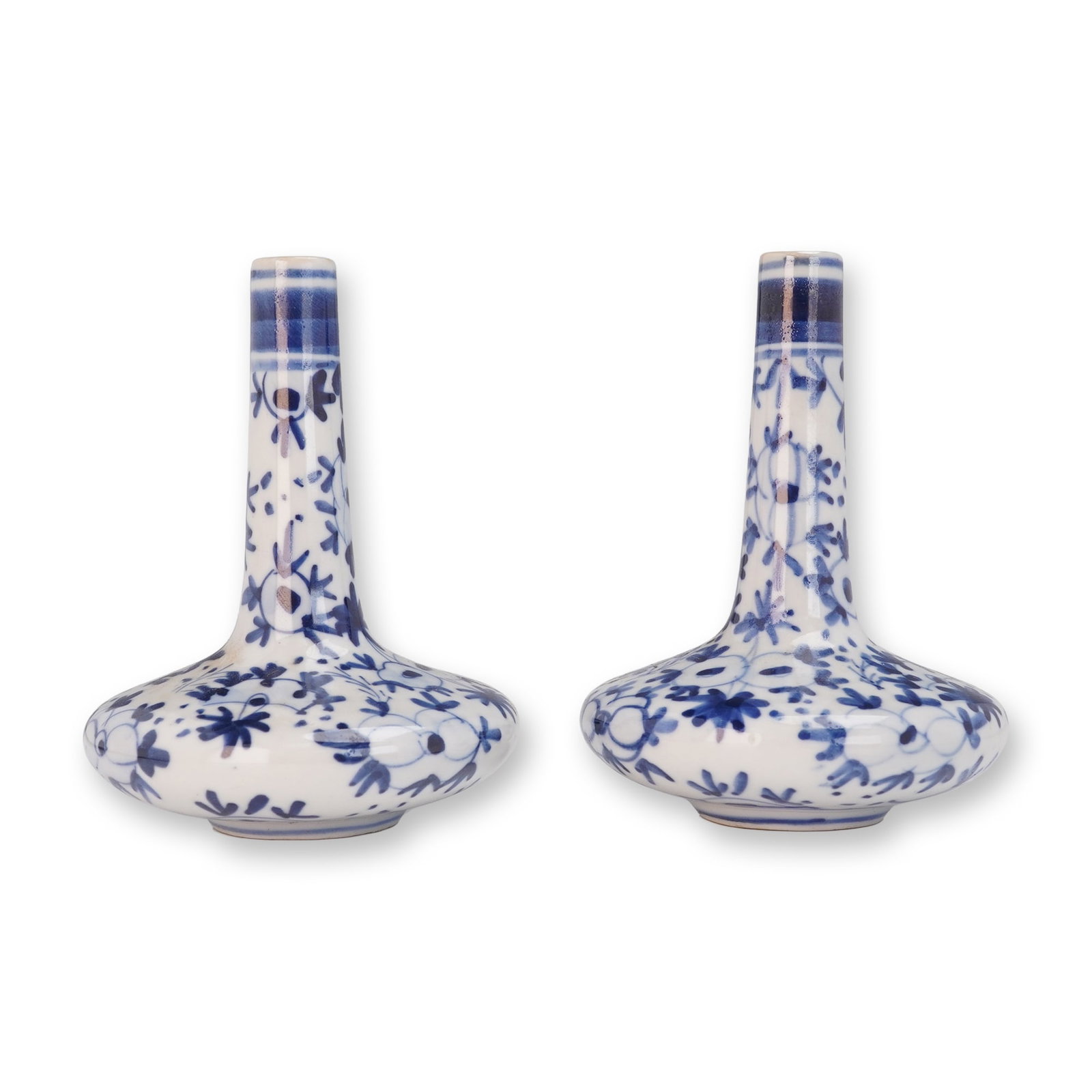 Pair of Chinese Blue and White Miniature Bottle Vases: Featuring two vases, slender elongated necks and rounded bodies. Each vase is decorated with hand-painted floral and foliate motifs in cobalt blue underglaze, forming continuous patterns around the su