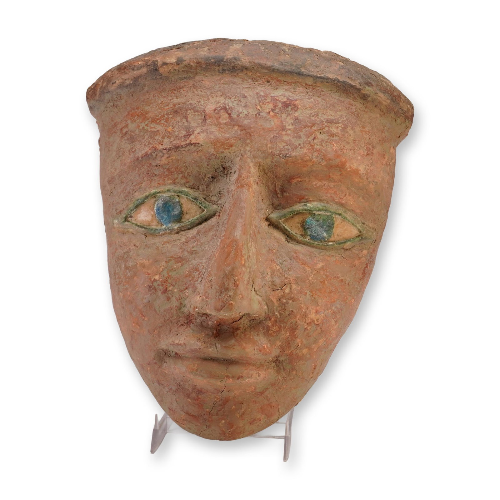Egyptian Polychrome Mask (Ex-James Coburn Collection): A wooden Egyptian mask painted in polychrome, portraying a face with brown shading, blue eyes rimmed in green. Dimensions: 9.5"L x 7.5"W x 3.5"H Weight: 2.5 lbs