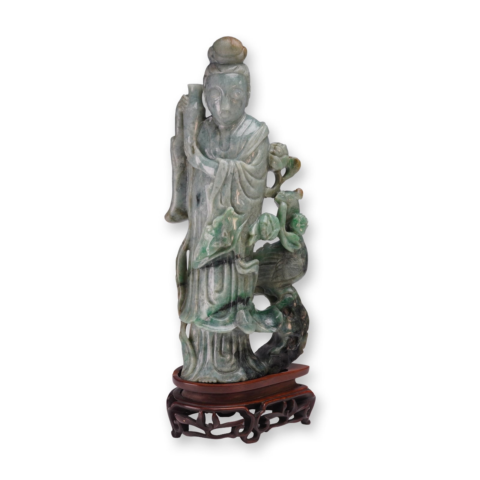 2pc Chinese Carved Jadeite Guanyin Figurine with Base: The figure is shown standing in long, flowing robes, holding a vase in her hands. Intricate carving features floral motifs along the side, accompanied by a phoenix perched among open blossoms. The jad