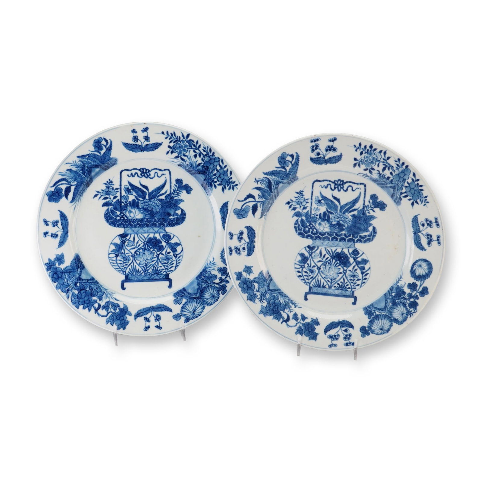 Pair of Chinese Blue and White Porcelain Dishes, Flower Basket, Jue Vessel Mark: A pair of Chinese blue and white porcelain dishes featuring blooming floral and leaf decorations along the rim, with a basket full of flowers at the center, and additional floral motifs on the undersi