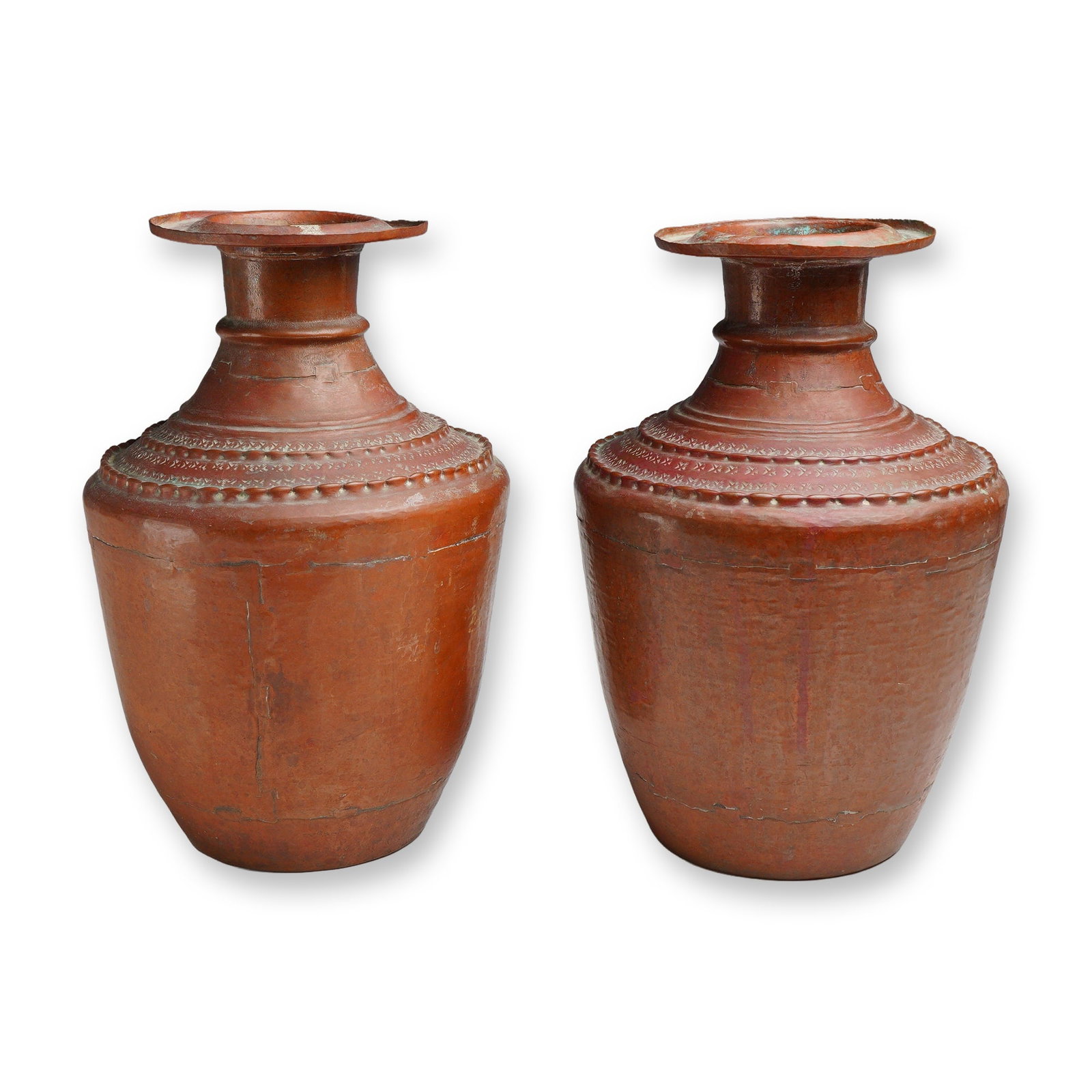 Pair of South Asian Hand Hammered Brass Urns: A pair of large brass urns or water vessels, traditionally known as gagri or lota style, originating from Northern India or Nepal. These vessels are constructed from multiple sheets of hand hammered m