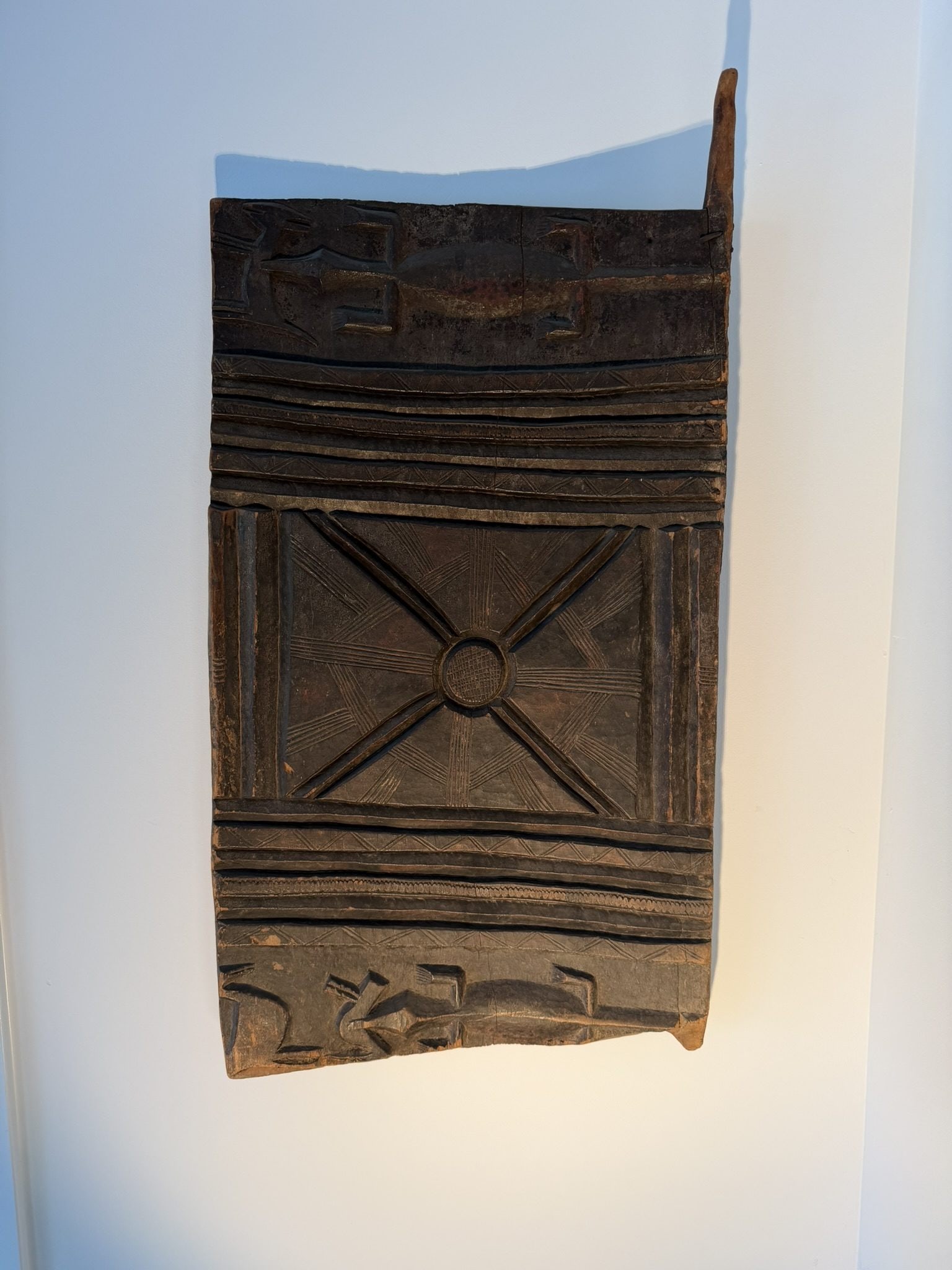 Senufo Carved Granary Door Fragment, Cote d'Ivoire, 19th/20th Century: A Senufo door from Cote d'Ivoire, carved from dense, dark hardwood, identified as a granary door fragment traditionally made by the Senufo people. These doors were historically used to protect stored 