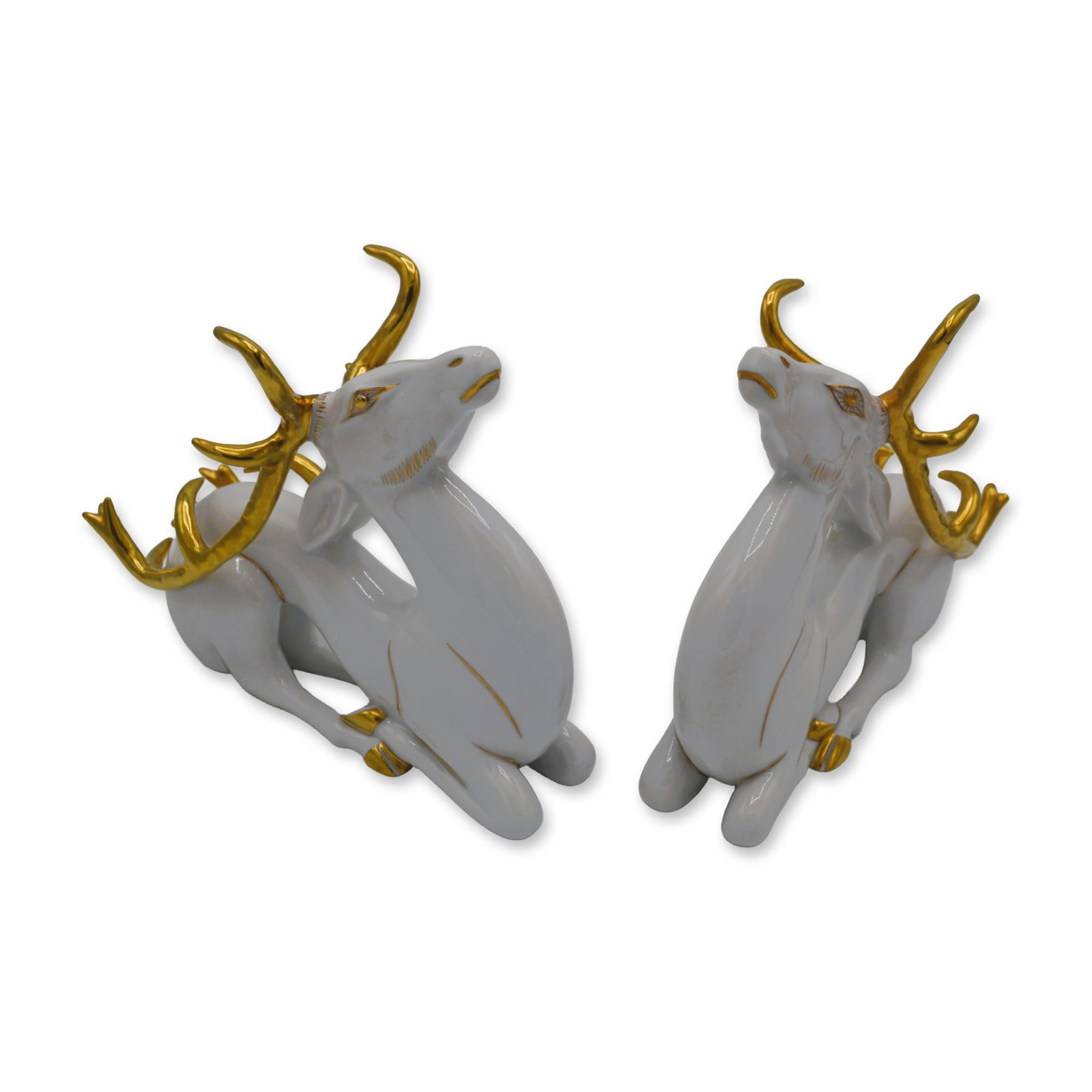 Herend Porcelain Sculptures White Christmas Deer, Seated, One Pair: Glazed Porcelain Decorated, Hand-painted, hand created by the Celebrated Artists of the Herend Porcelain Manufactory in Herend, Hungary. From the Classic Decorative Wildlife Collection, featuring The 