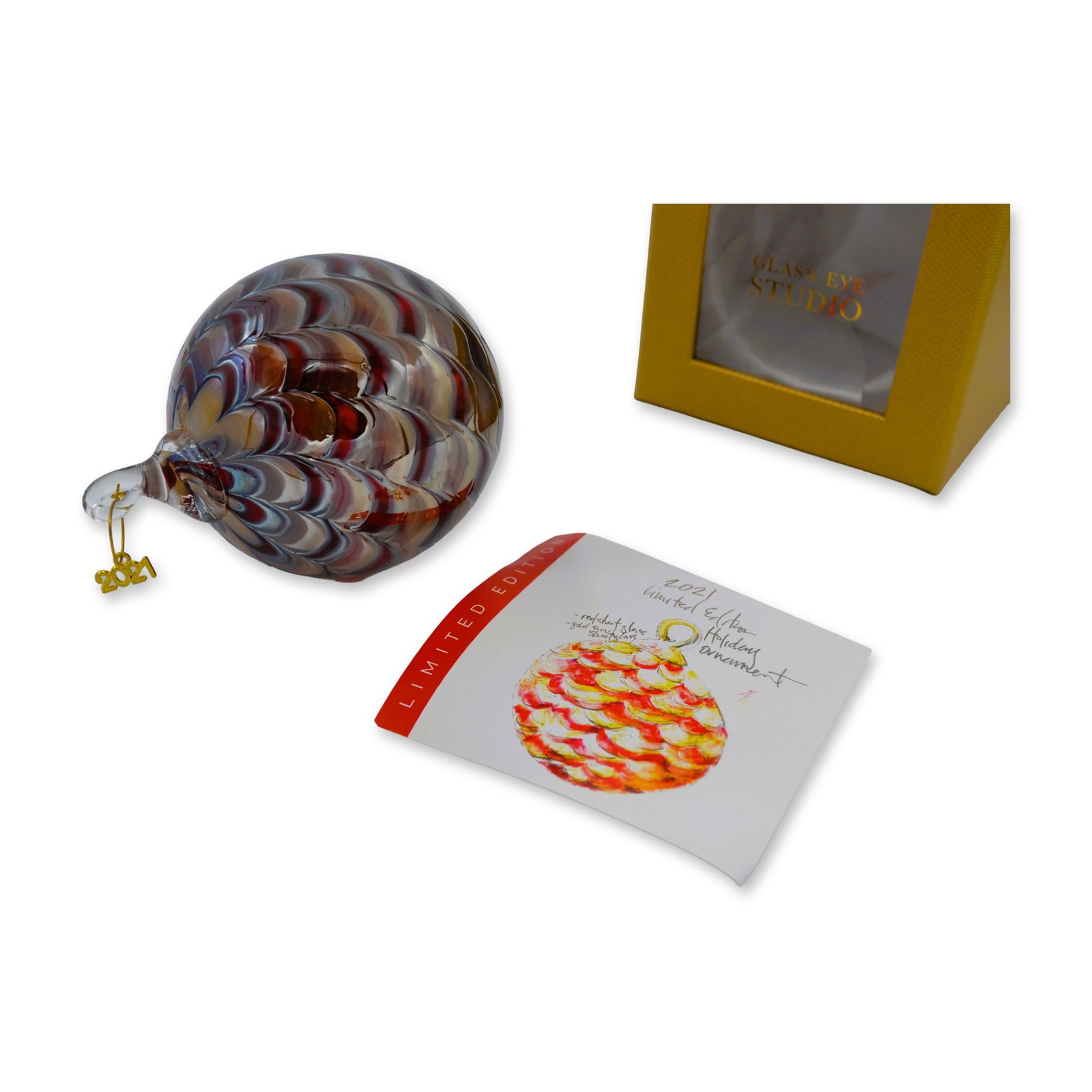 Glass Eye Studio LE Art Glass Holiday Ornament, 2021 W/Box: Glass Eye Studio presents the 2021 Limited Edition Holiday Ornament. Designed by Creative Director, Piper O'Neill, the Limited Edition holiday ornament is handmade by the artisan glassblowers in the S