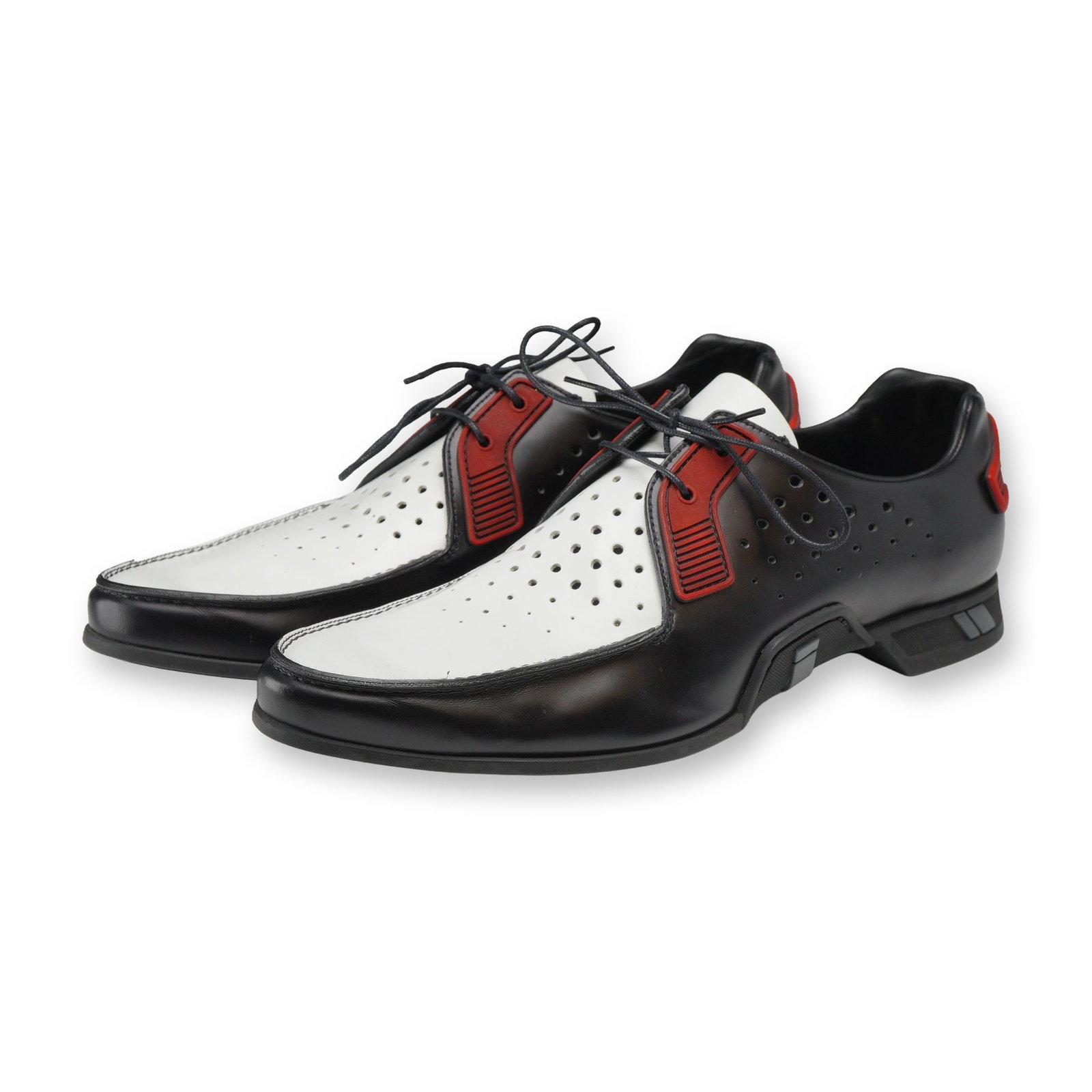 Pair of Prada Two-Tone Derby Shoes: Prada pair of men's two-tone tech toe lace-up leather derby shoes in Nero, white, and Rosso, size 8. The shoes feature smooth black leather quarters, perforated white leather vamps and tongues, techni