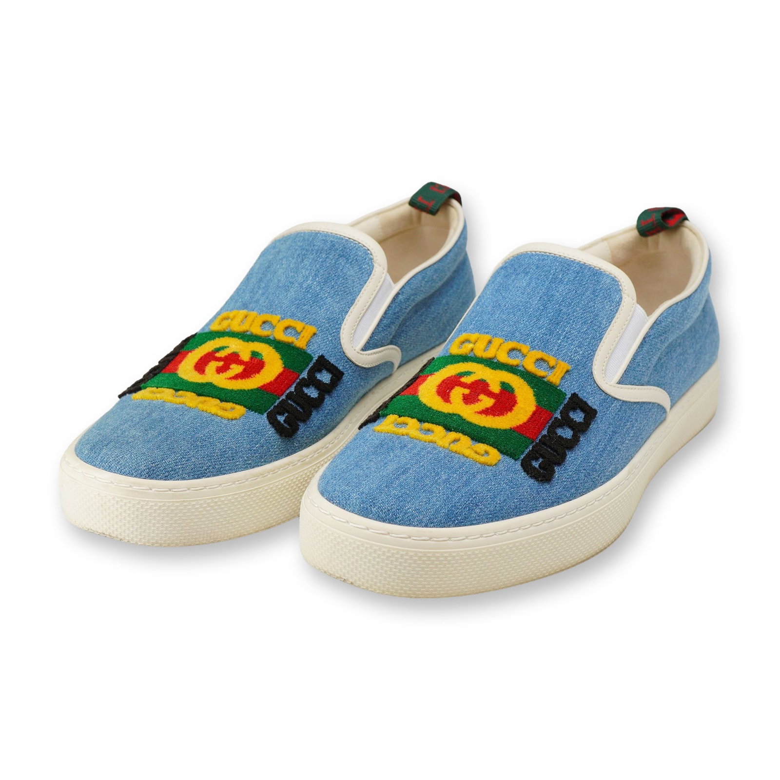 Pair of Gucci Kura Denim Slip On Sneakers Size 8: Pair of Gucci Kura slip-on sneakers in light blue denim, men's US size 8. The uppers are constructed from chambray-style light blue denim canvas trimmed with cream leather piping, white elastic side g