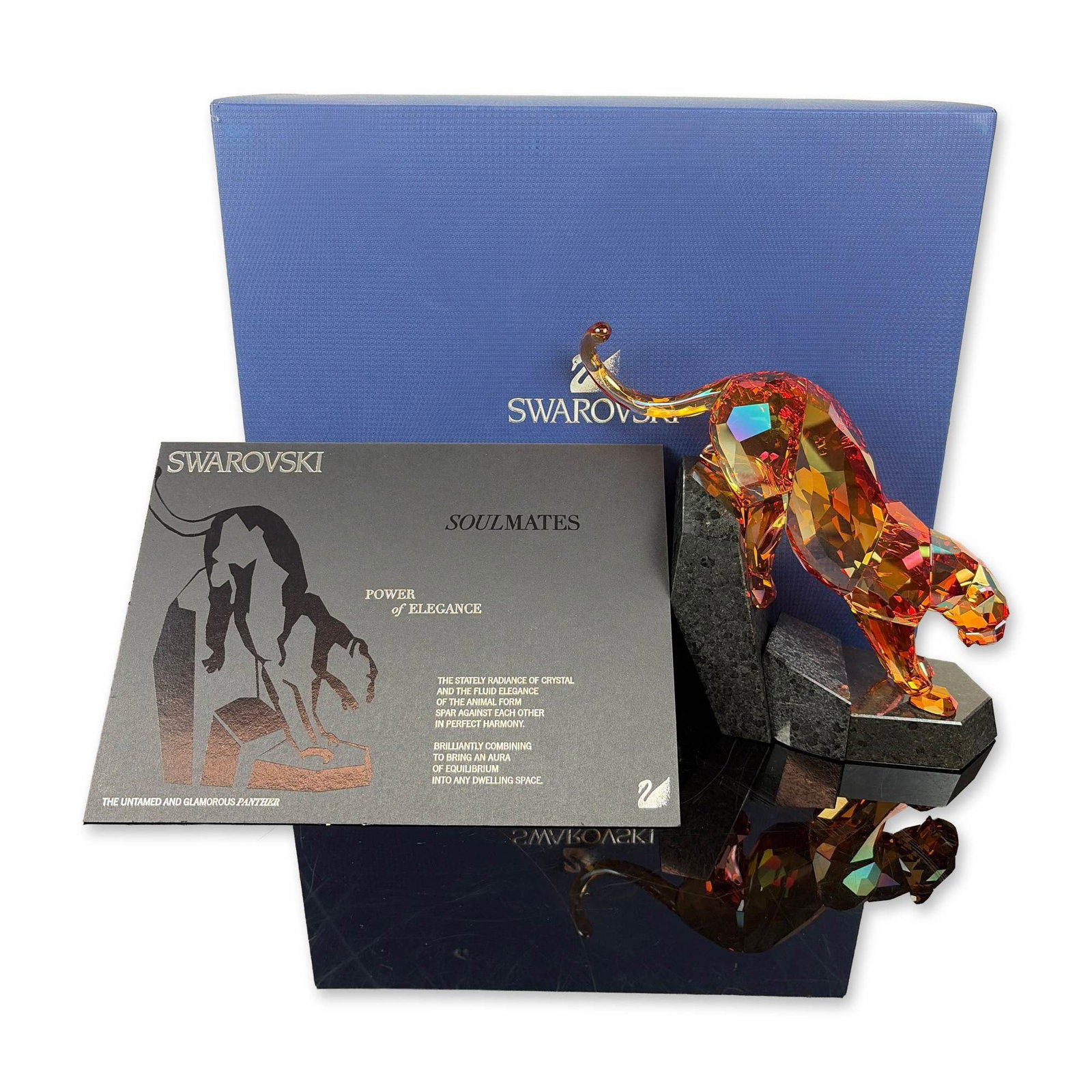 Swarovski Soulmates Limited Edition Orange Shine Crystal Panther Figurine: Titled Power of Elegance, this piece is crafted from fully faceted crystal with an iridescent Orange Shine or Dorato finish, set atop a multi-angled dark speckled granite base. It features an etched S
