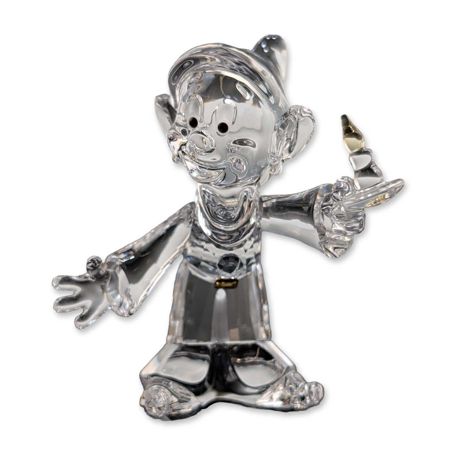 Swarovski Disney Crystal Figurine, Dopey: Swarovski Disney collection crystal figurine depicting the character Dopey from Snow White and the Seven Dwarfs. The figure is rendered in clear faceted crystal, featured in a standing pose wearing an