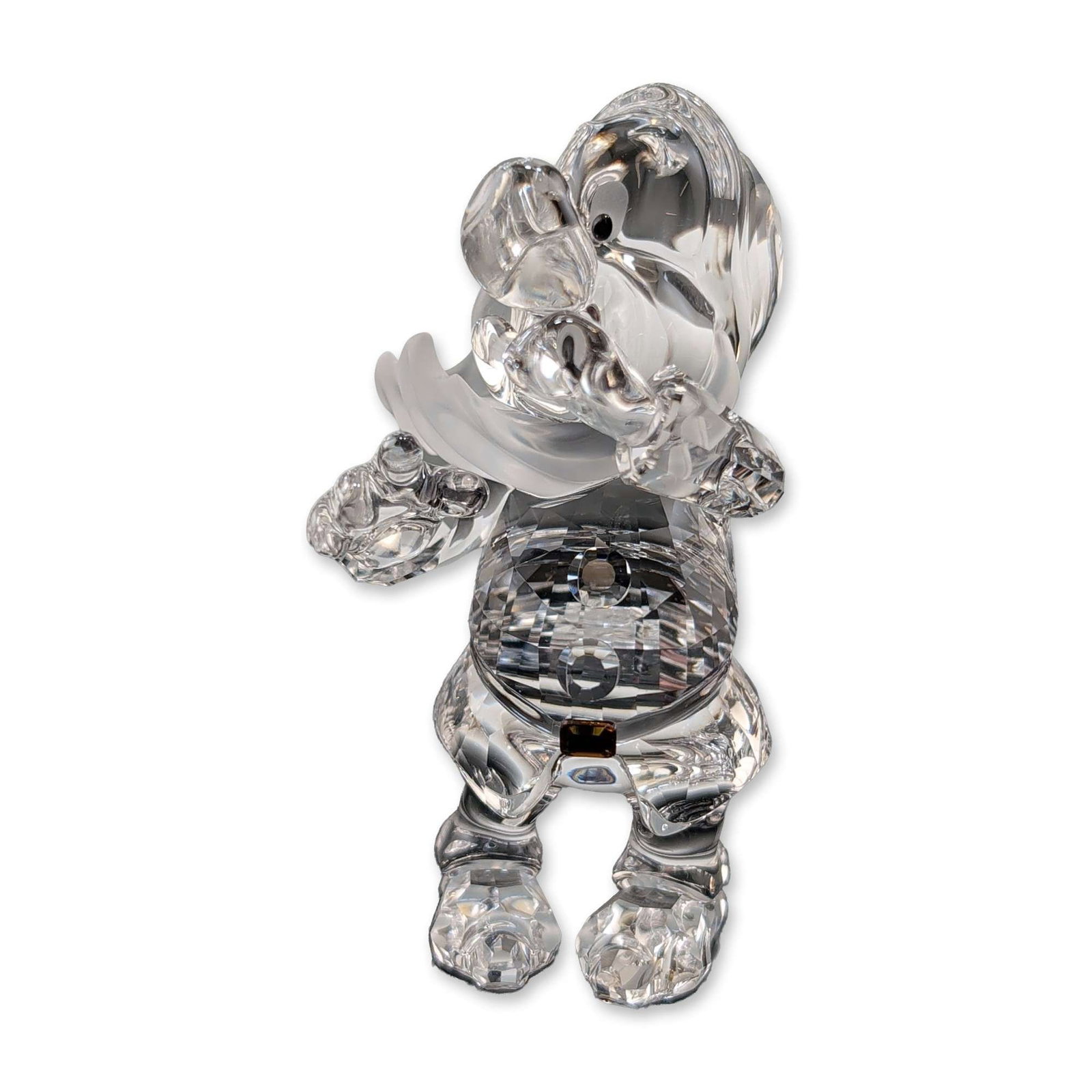Swarovski Disney Crystal Figurine, Sneezy: Swarovski Disney series crystal figurine depicting Sneezy from the 1937 animated film Snow White and the Seven Dwarfs. The figure is executed in multi-faceted clear lead crystal with a frosted crystal