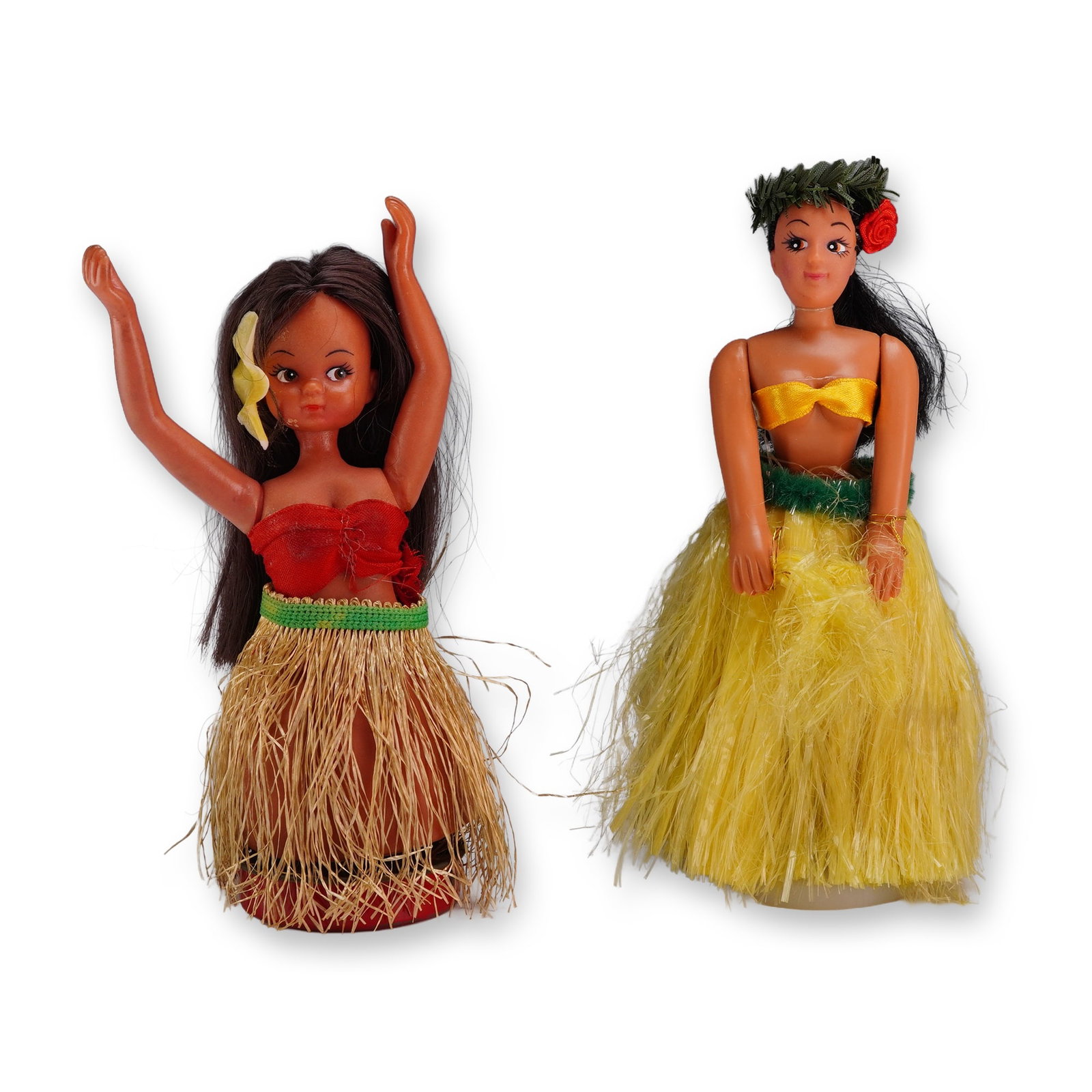 2pc Vintage Hula Girl Nodders: Pair of hula girl nodders in molded plastic and synthetic fiber, featuring rooted dark hair and fabric costumes. One figure is dressed in a red bandeau with a natural raffia skirt and a yellow flower 