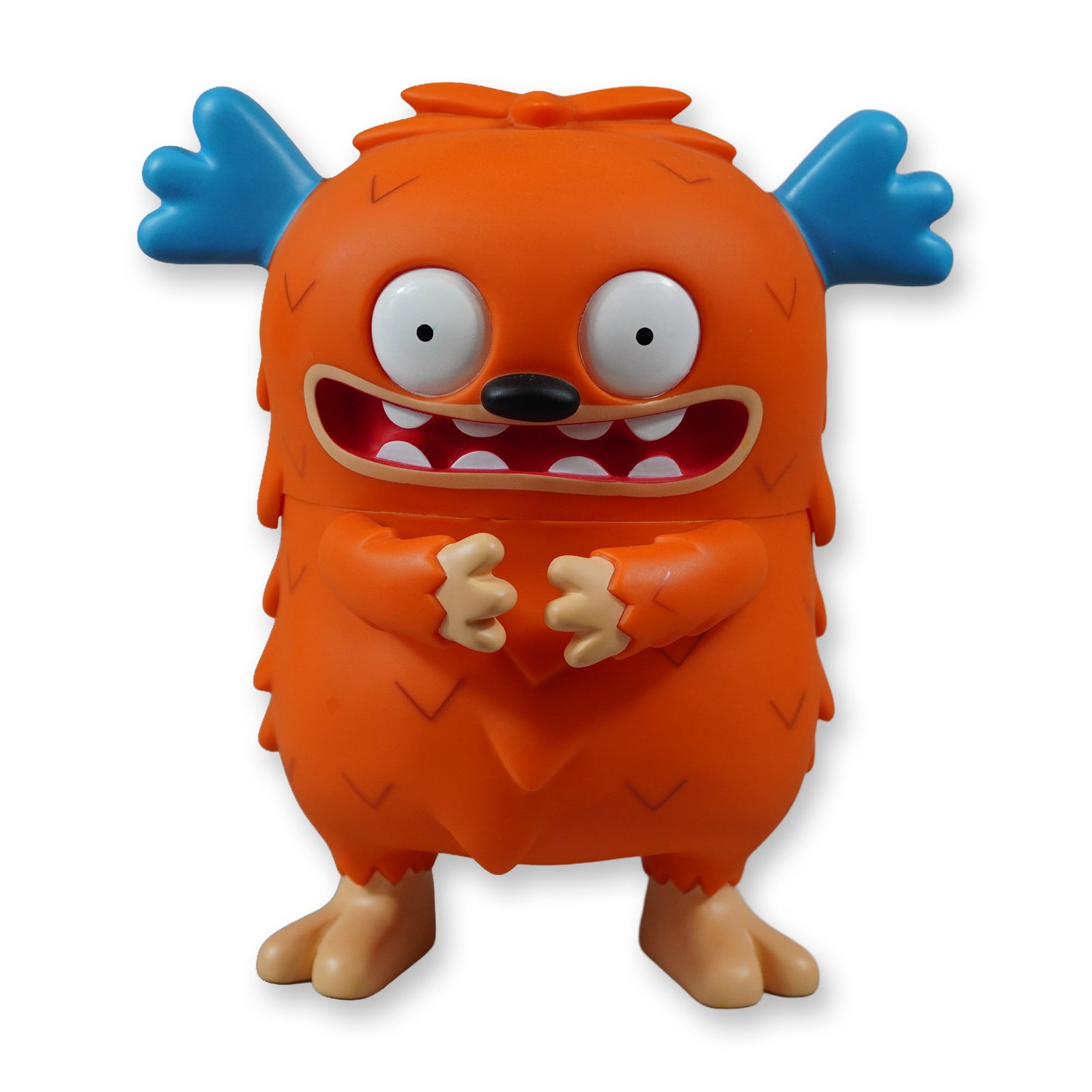 Toy2R Uglydolls Choco Figure: Toy2R. Choco figurine in orange rotocast vinyl from the Uglydolls series by creators David Horvath and Sun-Min Kim. Featuring two blue head appendages, a debossed chevron body pattern, large white cir