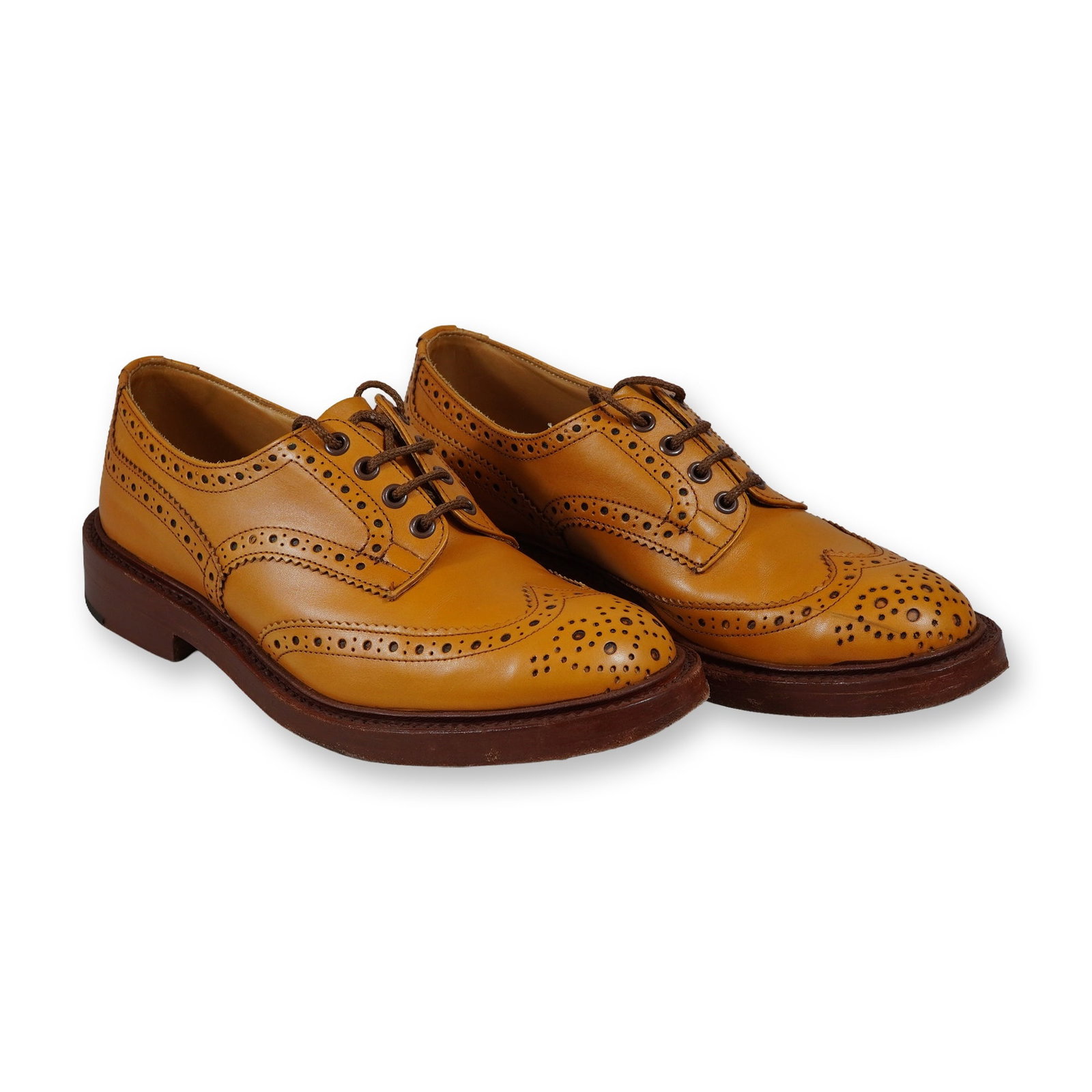 Men's Tricker's England Acorn Antique Leather Bourton Country Shoes: A pair of Tricker's Bourton country brogue Derby shoes in Acorn Antique tan leather. Handcrafted in Northampton, England, these shoes feature a classic wingtip design with decorative perforations and 