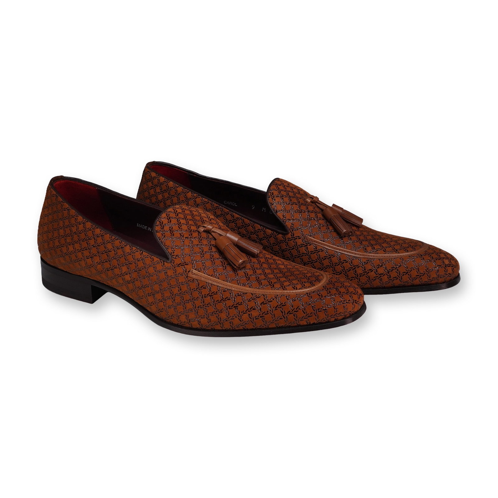 Mezlan Carol Embossed Suede Tassel Loafers: Pair of men's tassel loafers in the Carol style, featuring cognac tan embossed suede uppers with a woven-texture pattern. The construction includes leather tassels, a dark burgundy leather lining, and